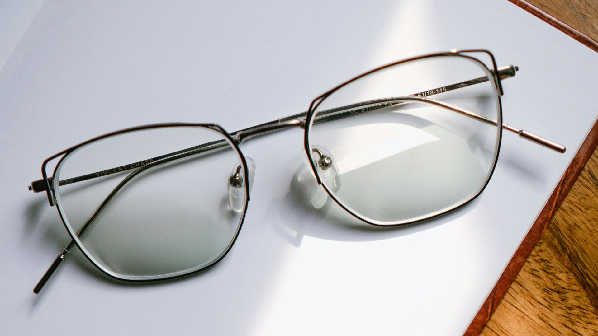 black framed eyeglasses on white table