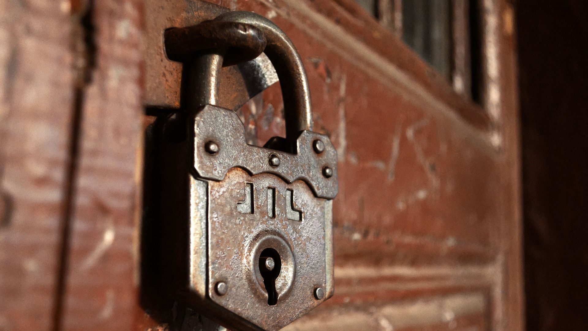 an old padlock on a wooden door
