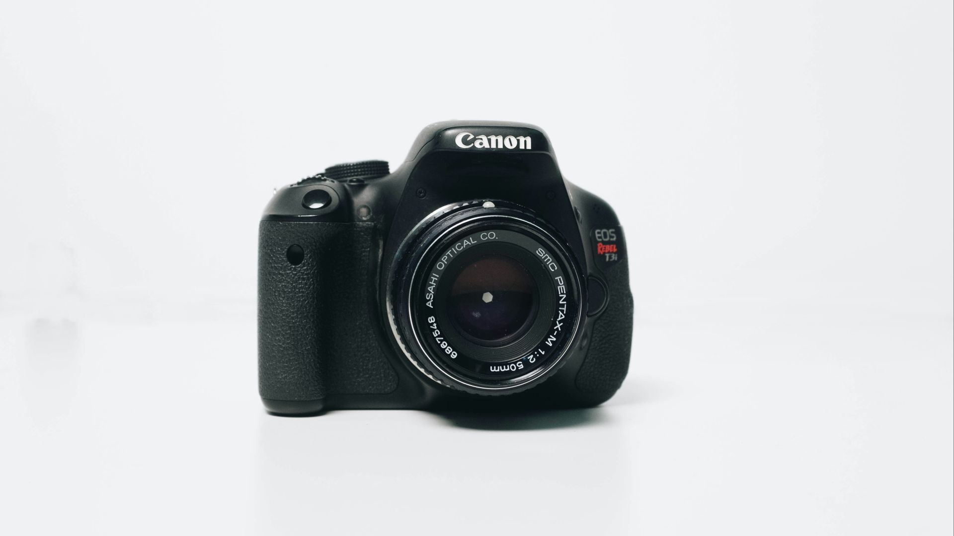 black Canon EOS Rebel-series DSLR camera