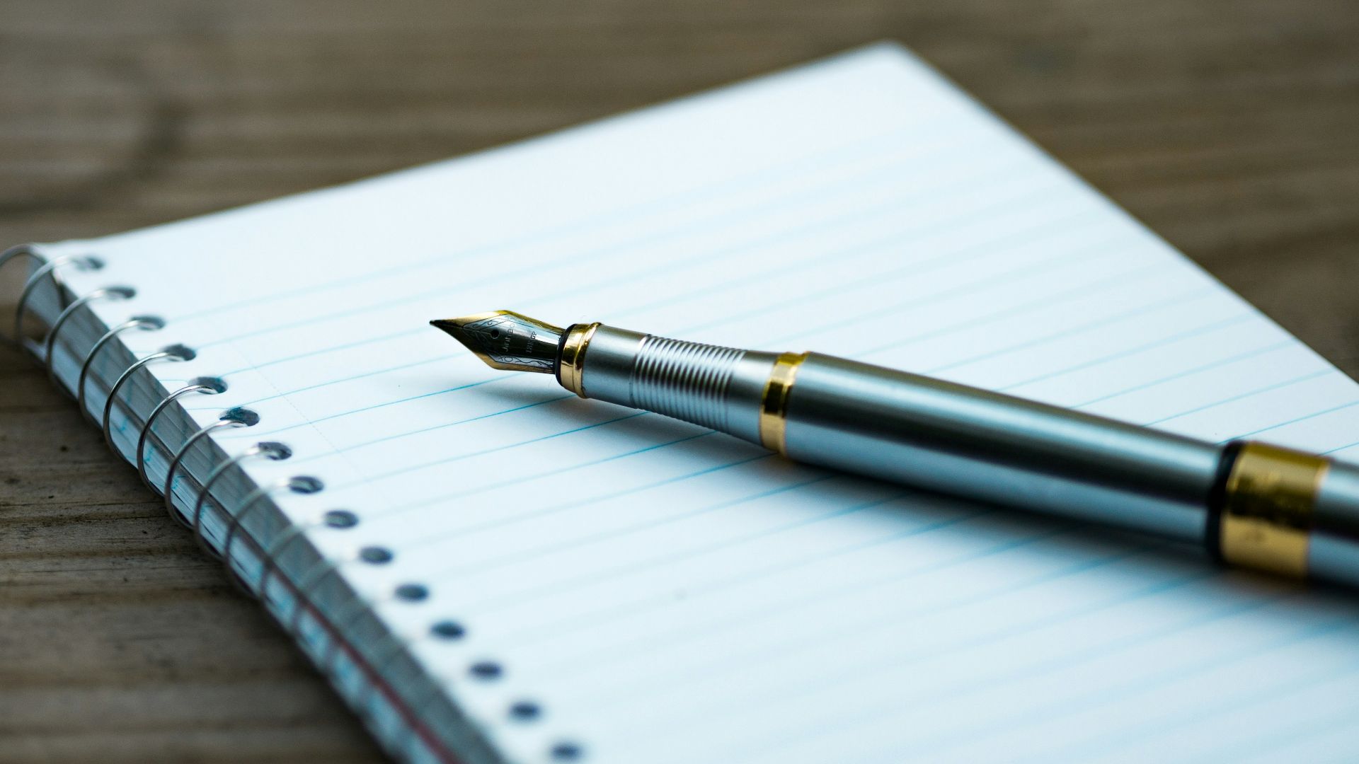 fountain pen on spiral book