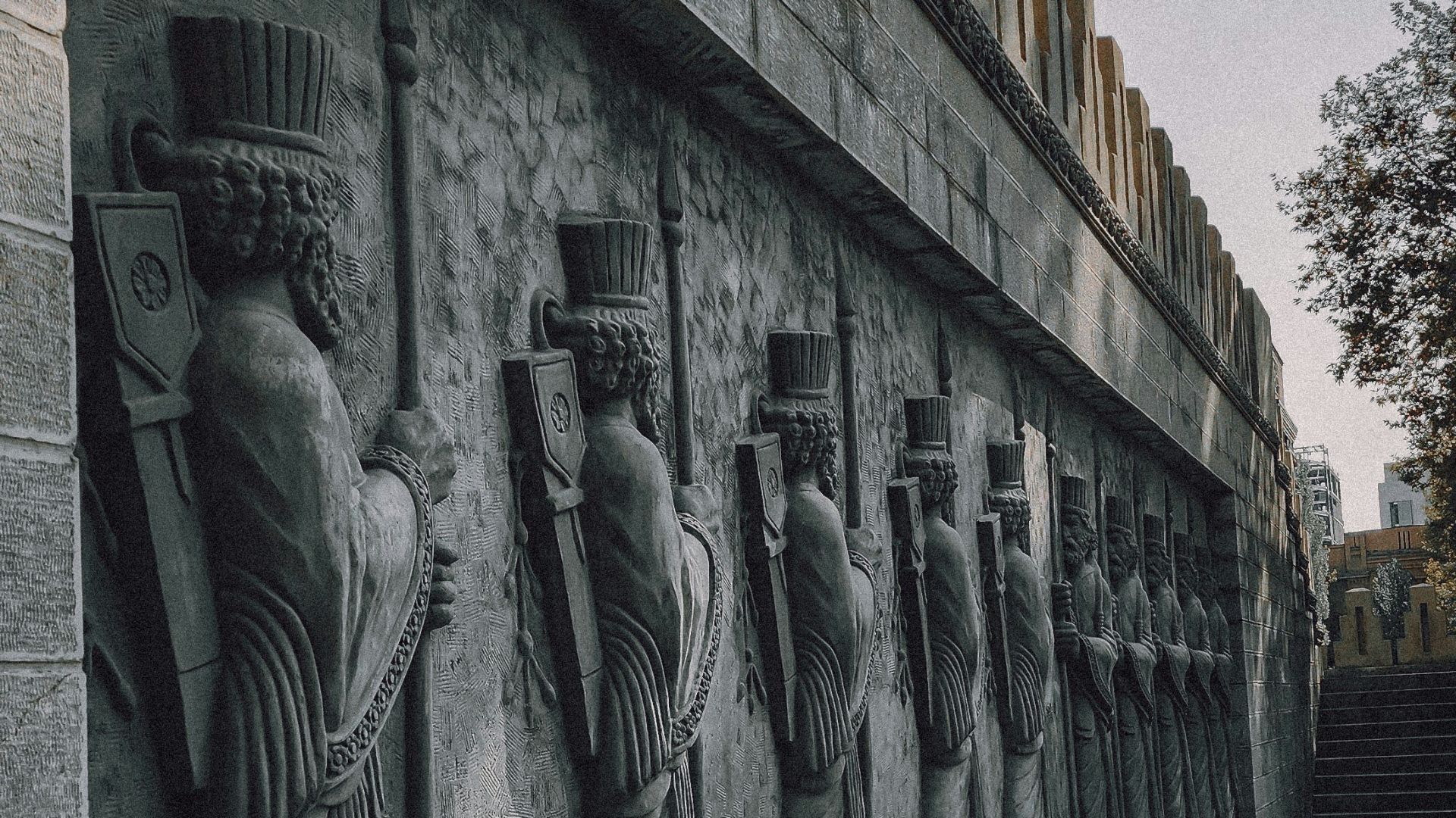 a row of statues on the side of a building