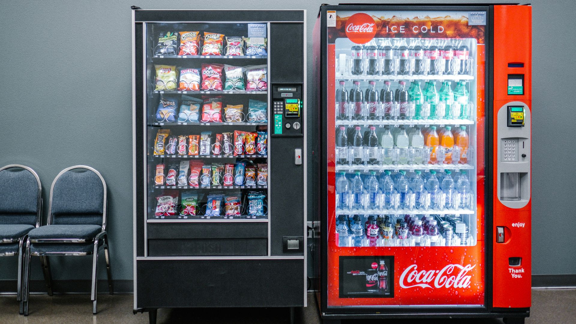 coca cola and coca cola bottles in black vending machine