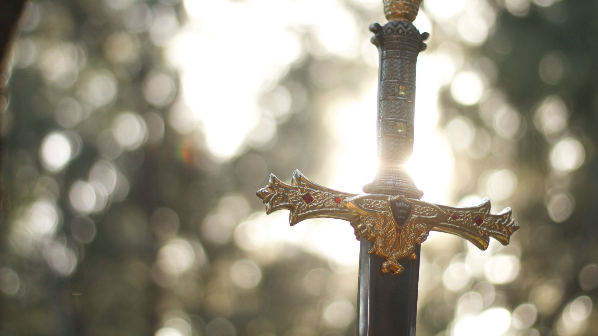 close-up photography of gold-colored and black sword