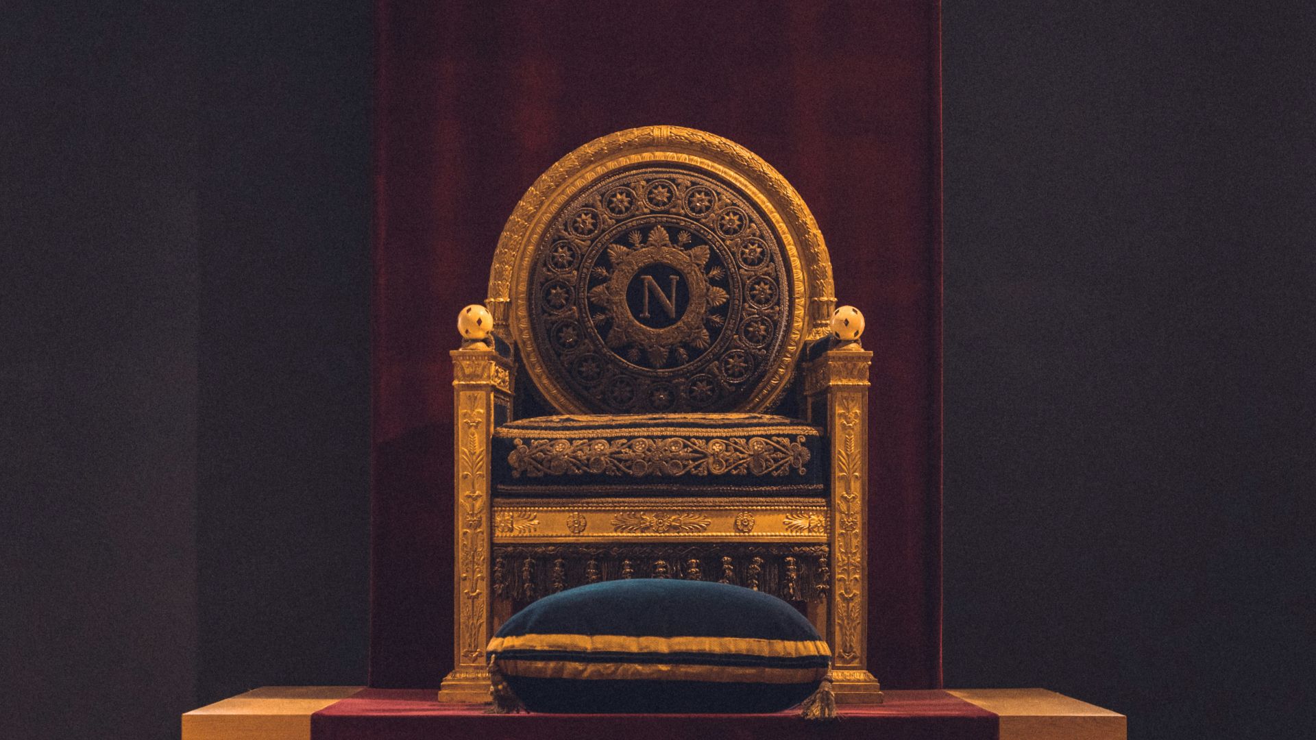 gray and black wooden chair with fabric cushion