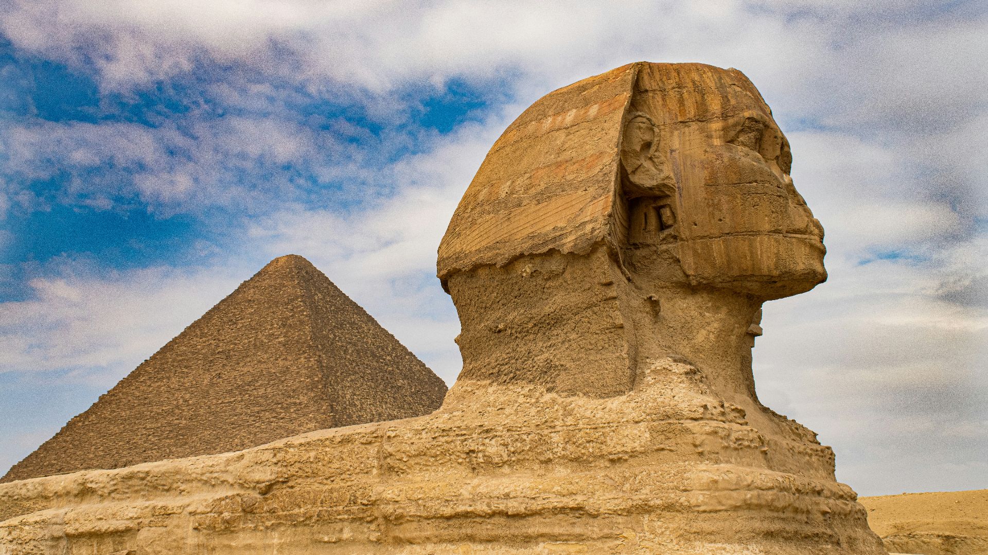 brown concrete statue under blue sky during daytime
