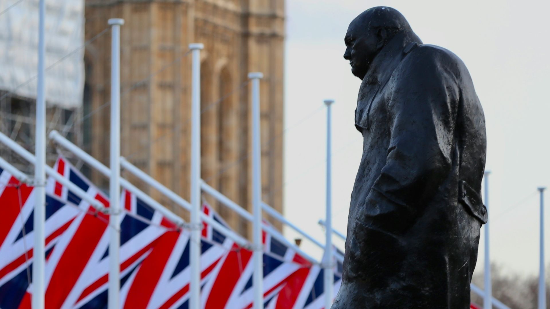 statue of man holding flag of us a near us a flag during daytime