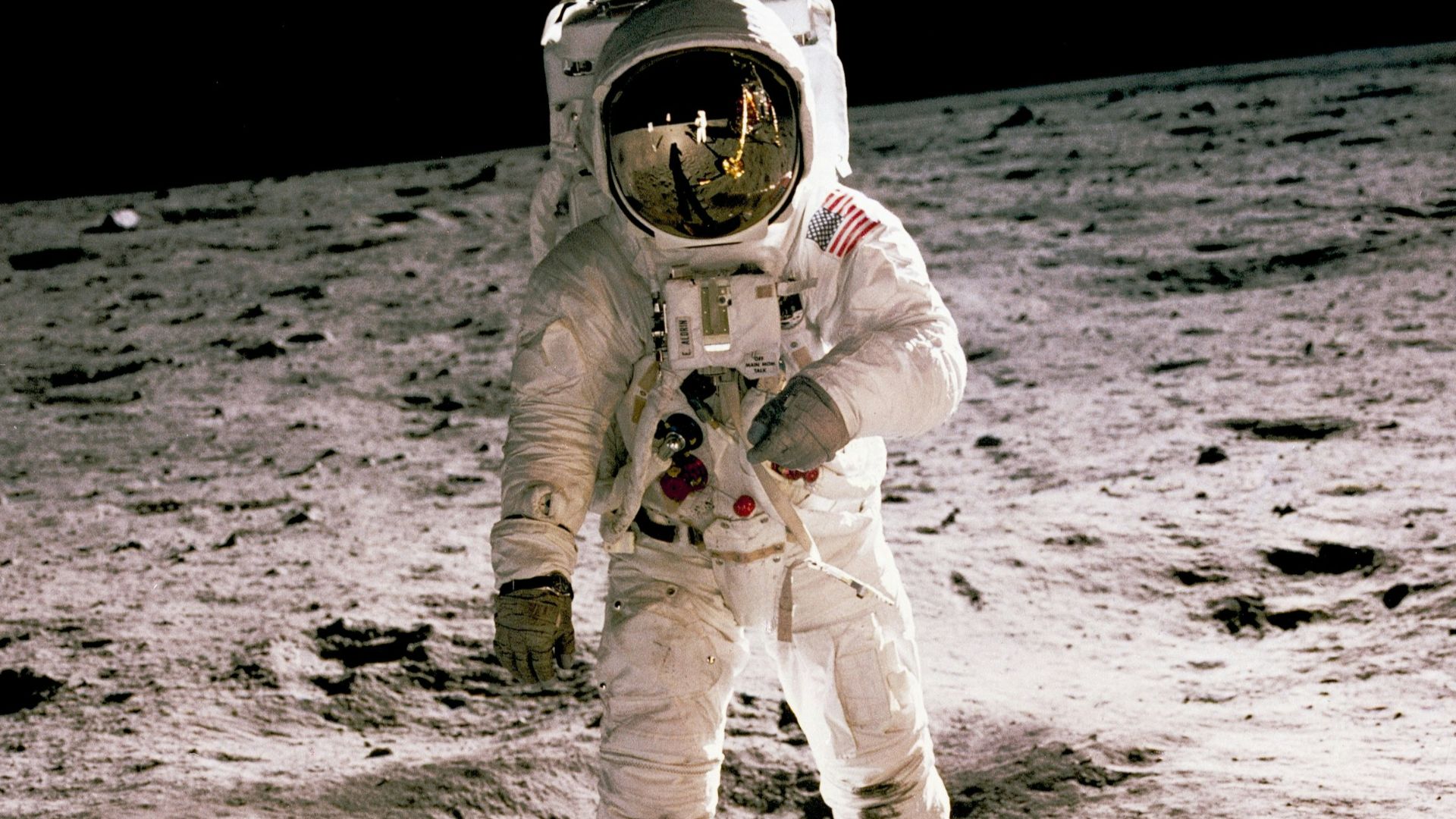 astronaut standing on gray sand