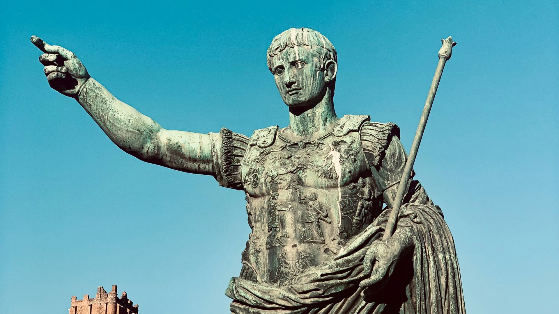 a statue of a man holding a staff