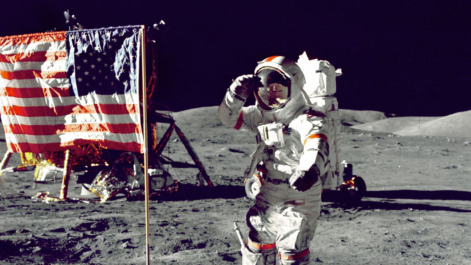 astronaut standing on moon beside U.S.A. flag