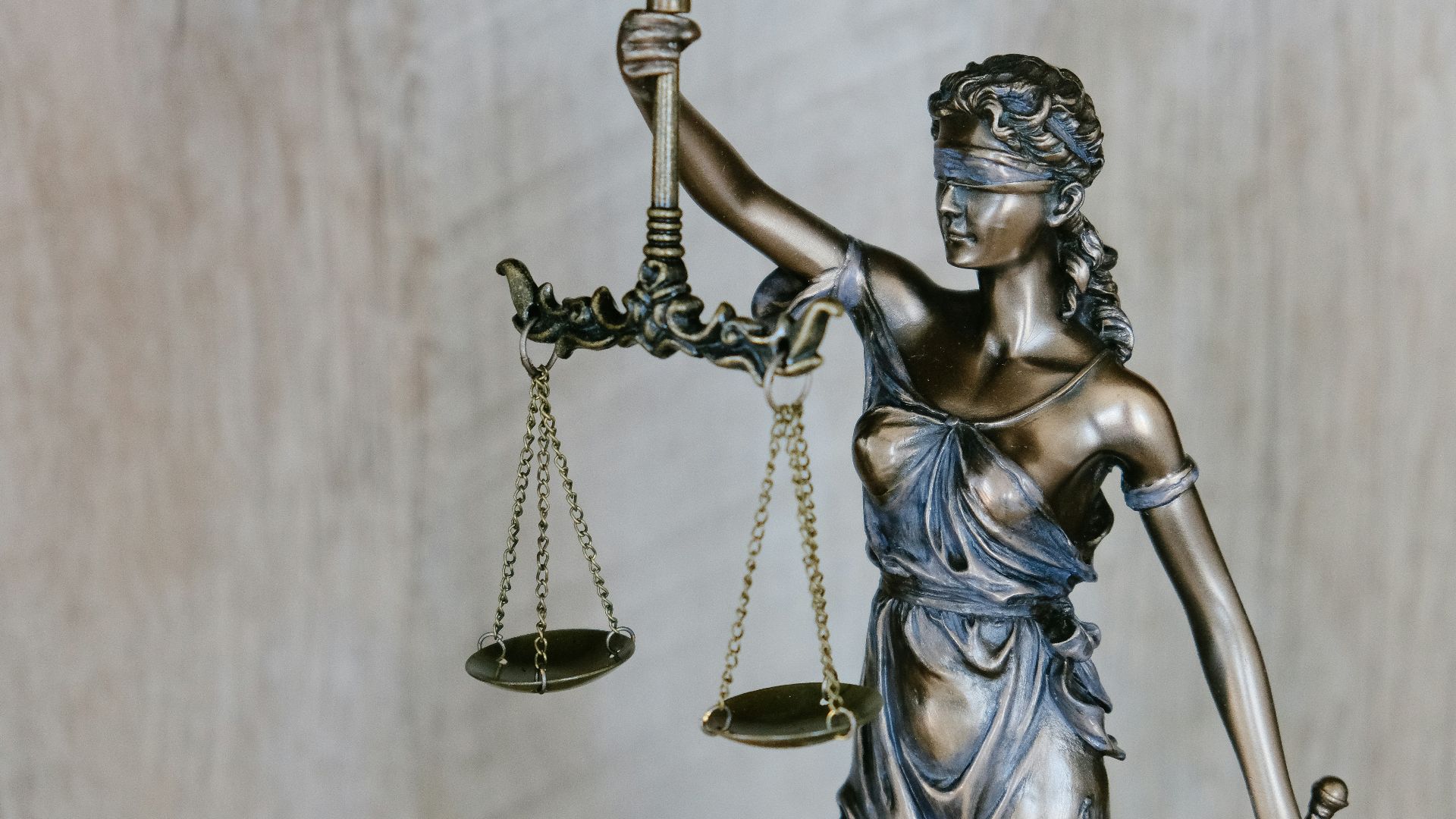 woman holding sword statue during daytime