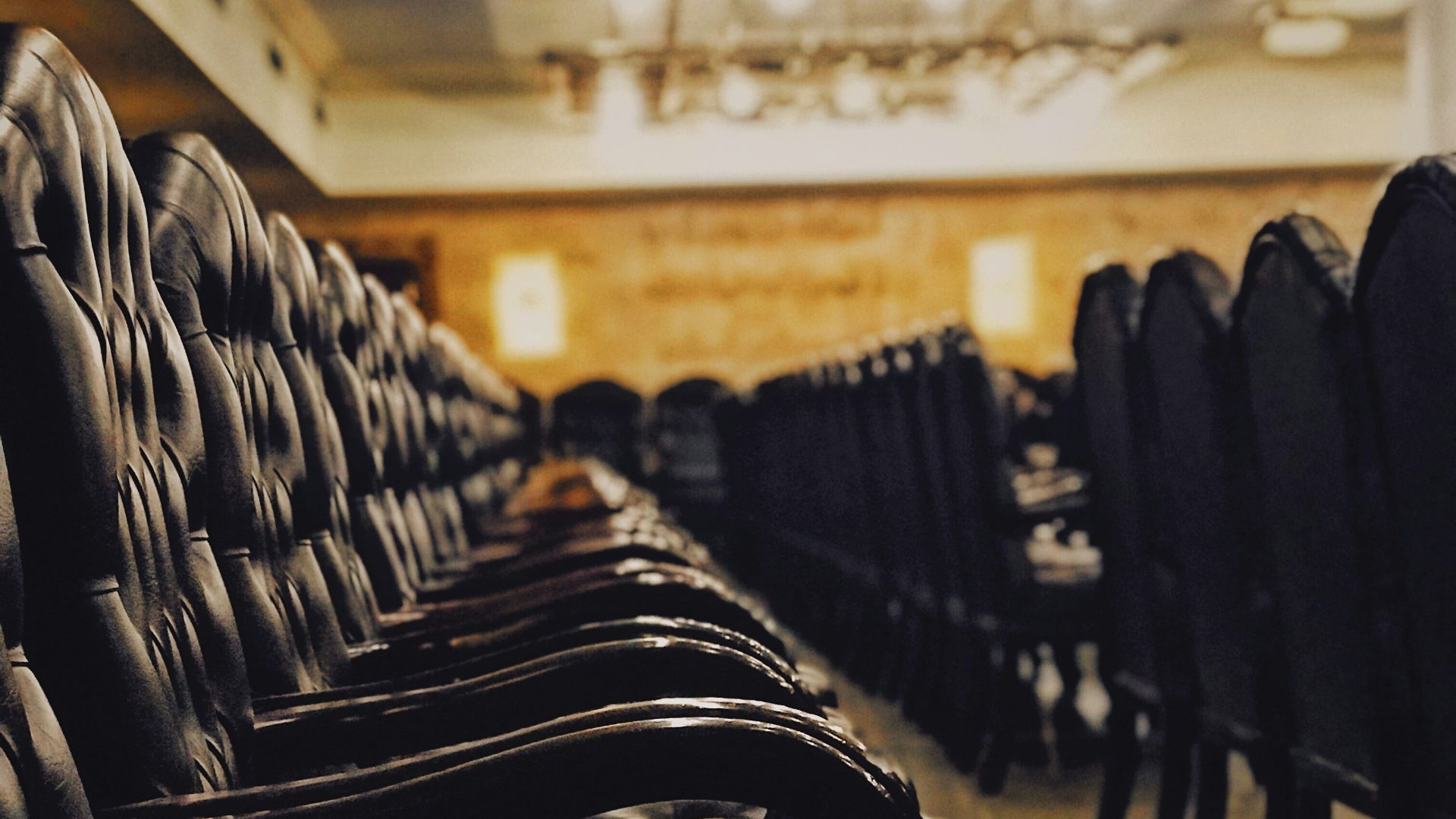 tufted black chairs inside building with no people