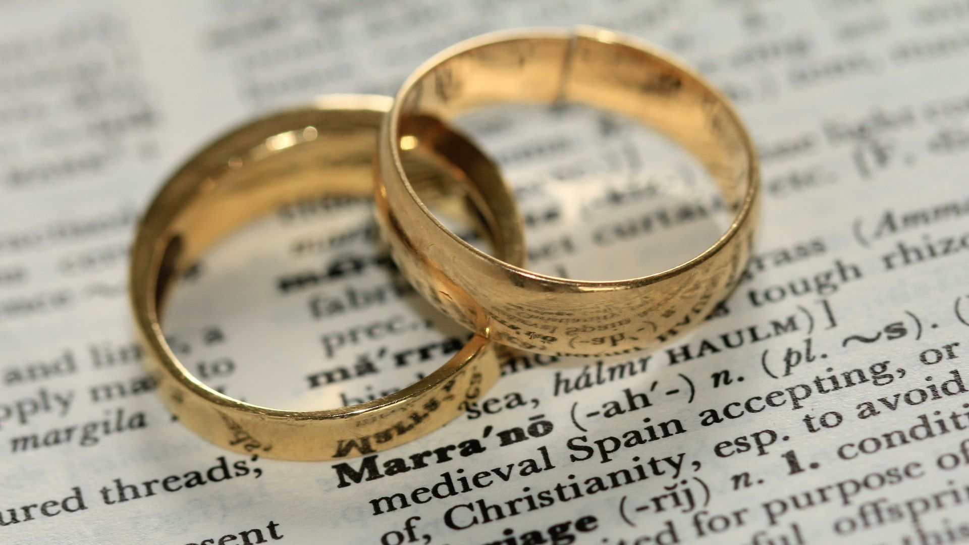 two gold-colored rings on paper