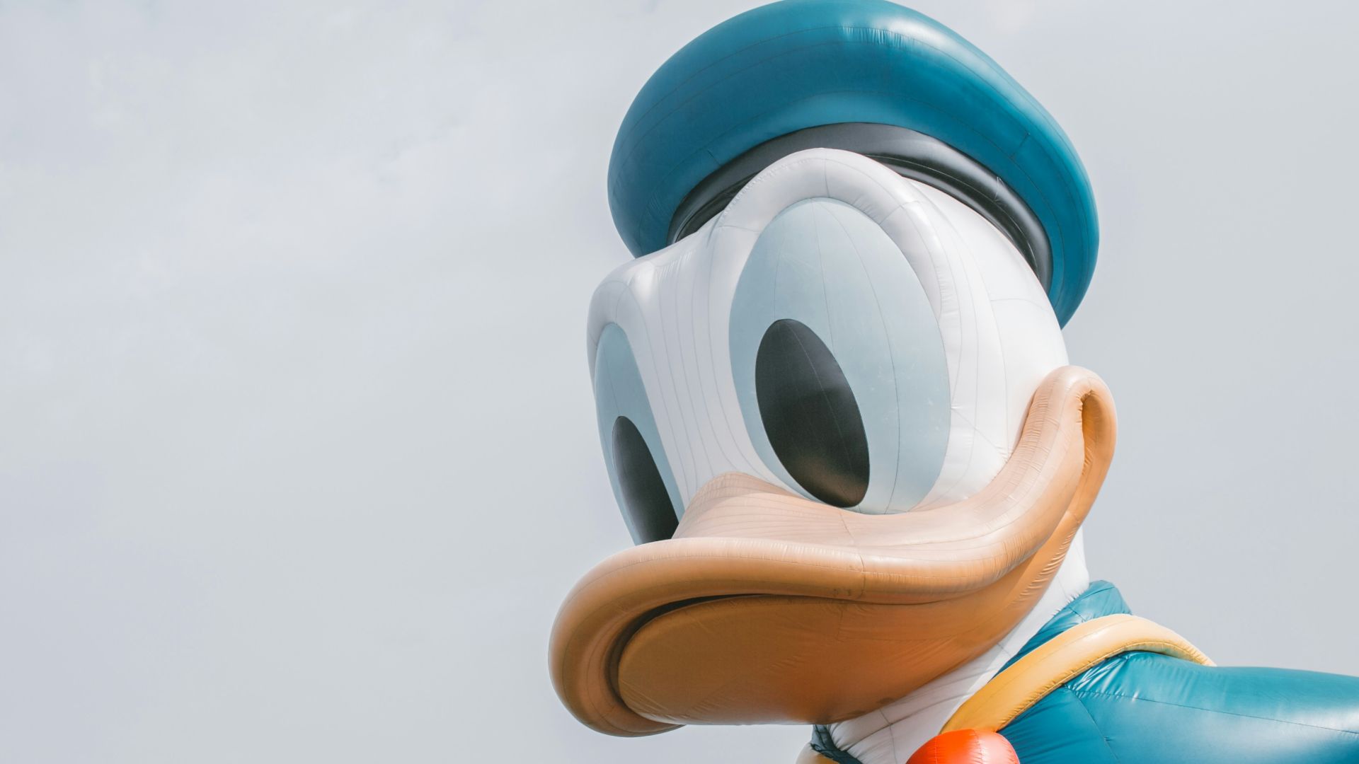 a large mickey mouse balloon with a bow tie