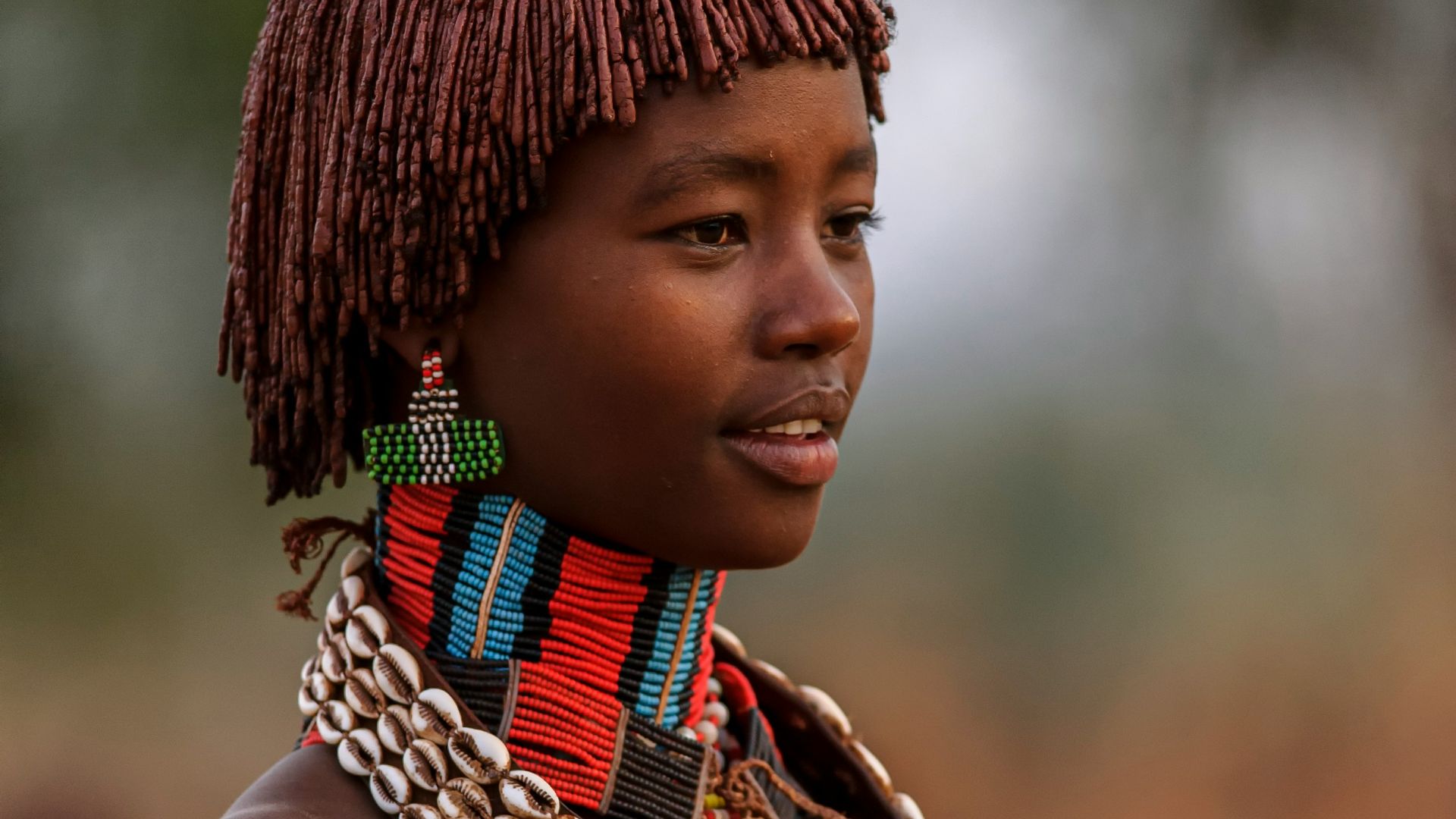 a woman with a necklace and headdress on