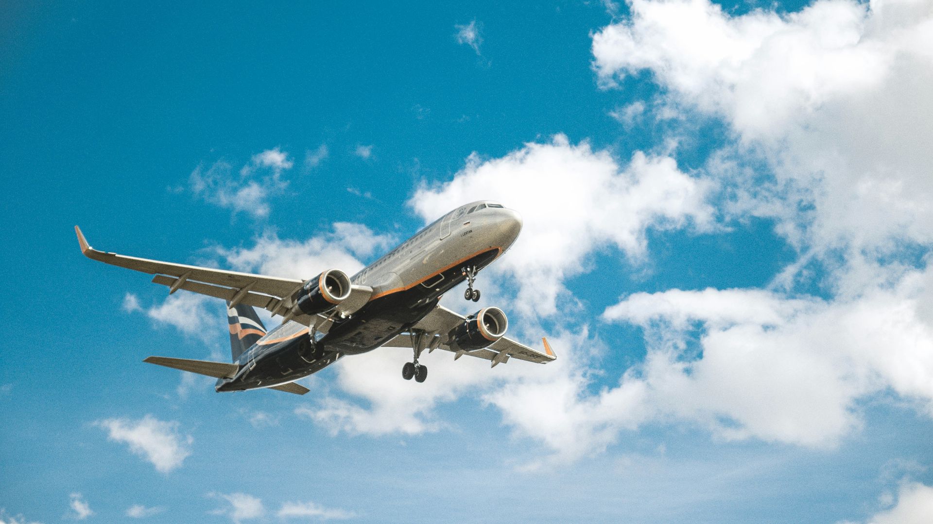 white airplane under blue sky during daytime