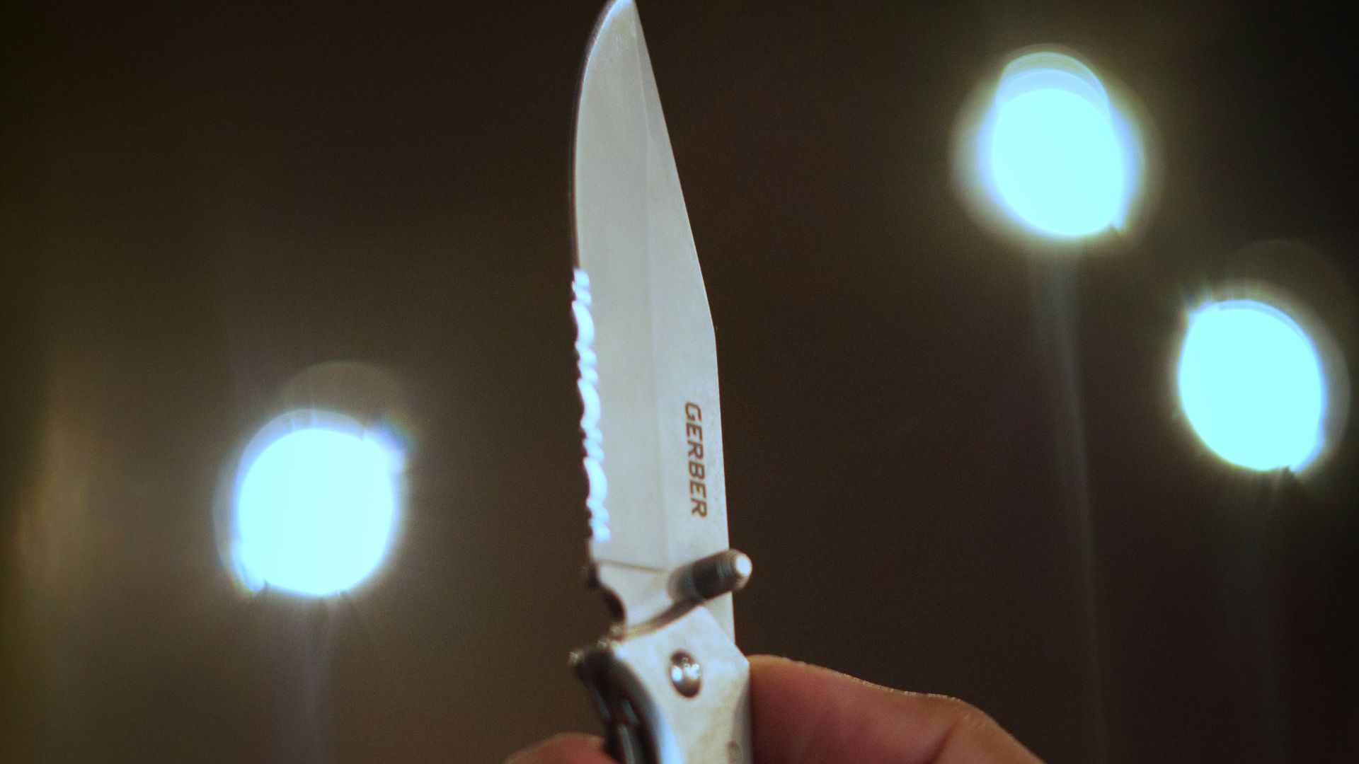 person holding silver and black scissors