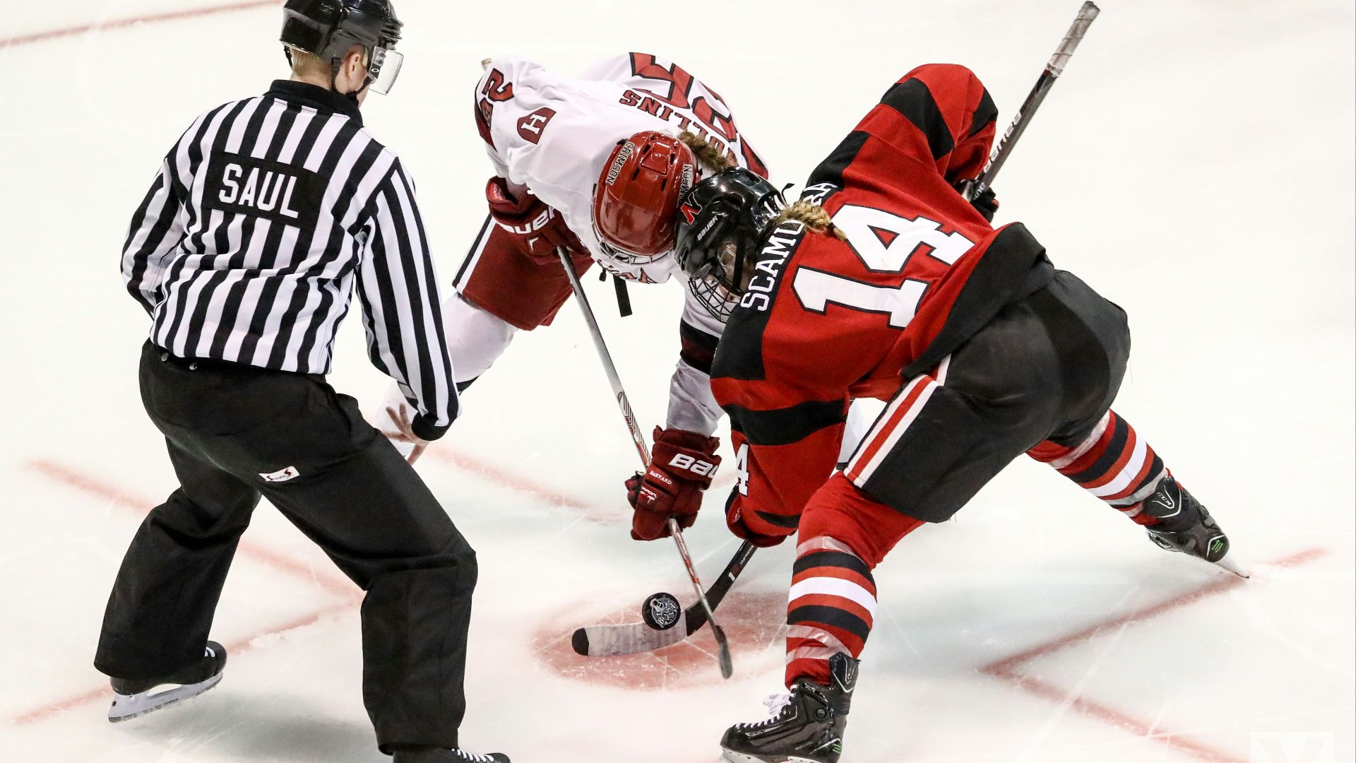 two persons playing ice hockey with referee
