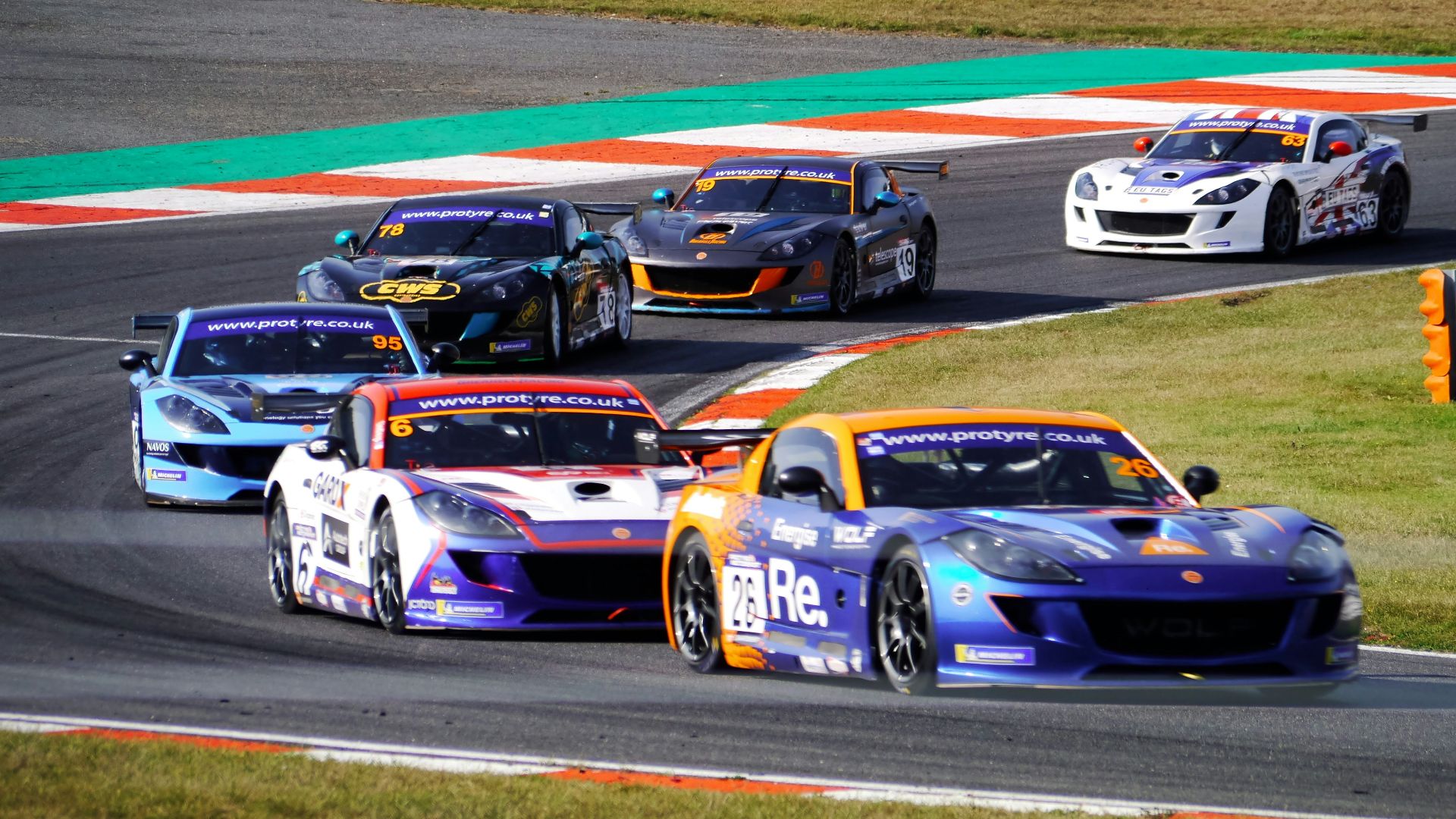 a group of cars racing on a race track