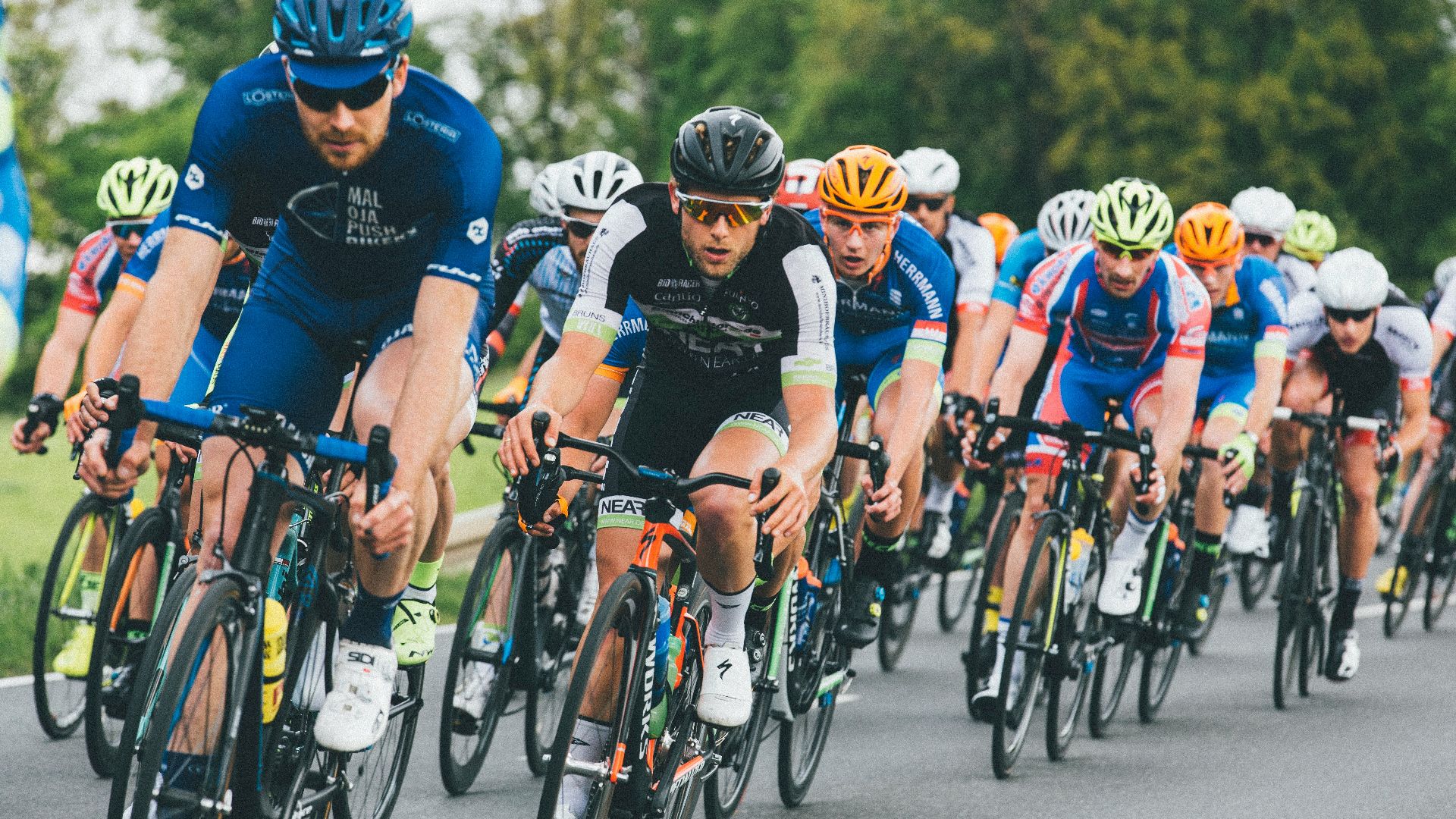 group of cyclist on asphalt road