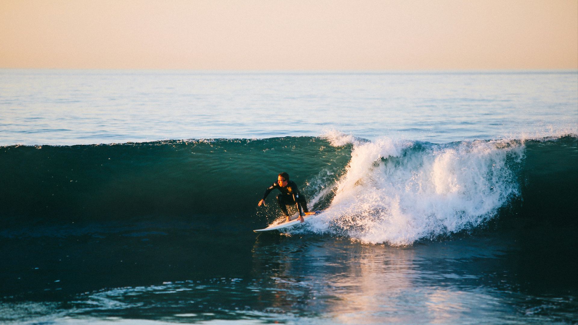 man surfing on ocean wave during daytime