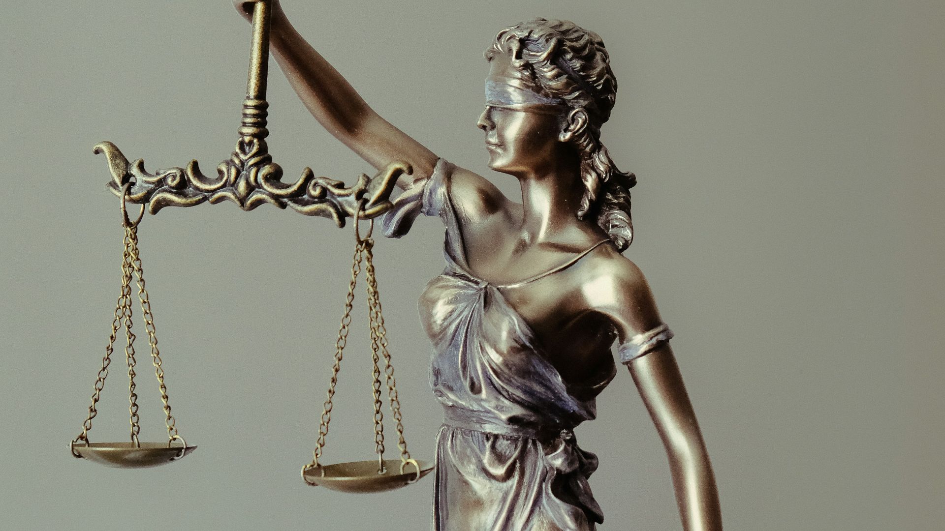 woman in gold dress holding sword figurine