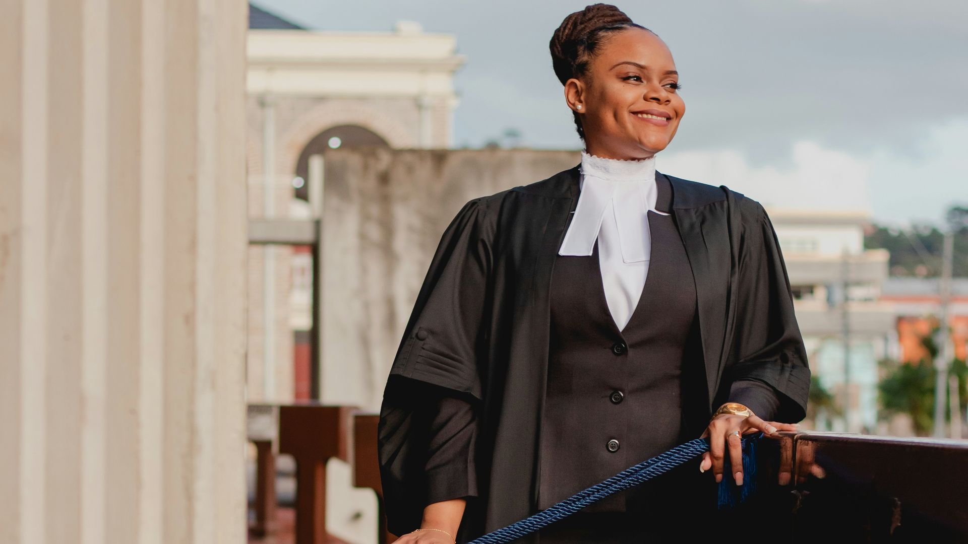 a woman in a black dress holding a blue bag