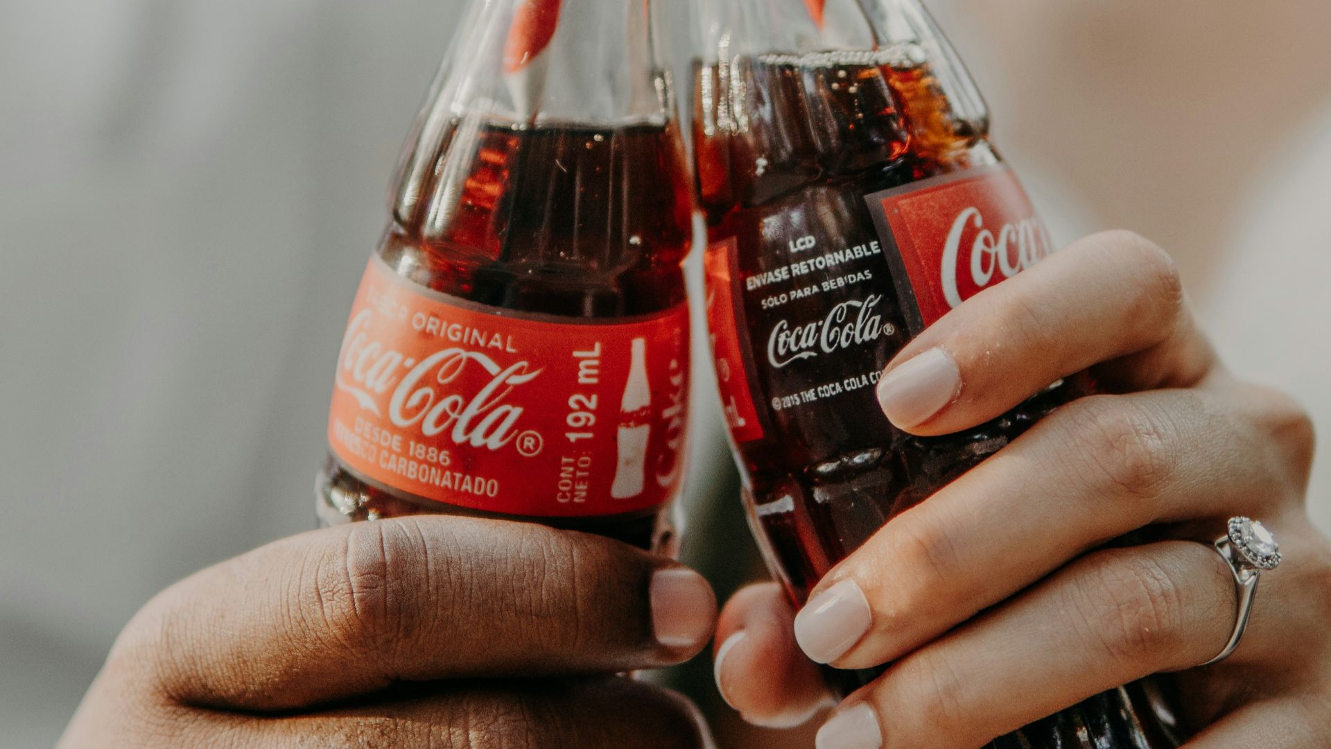 person holding coca cola bottle