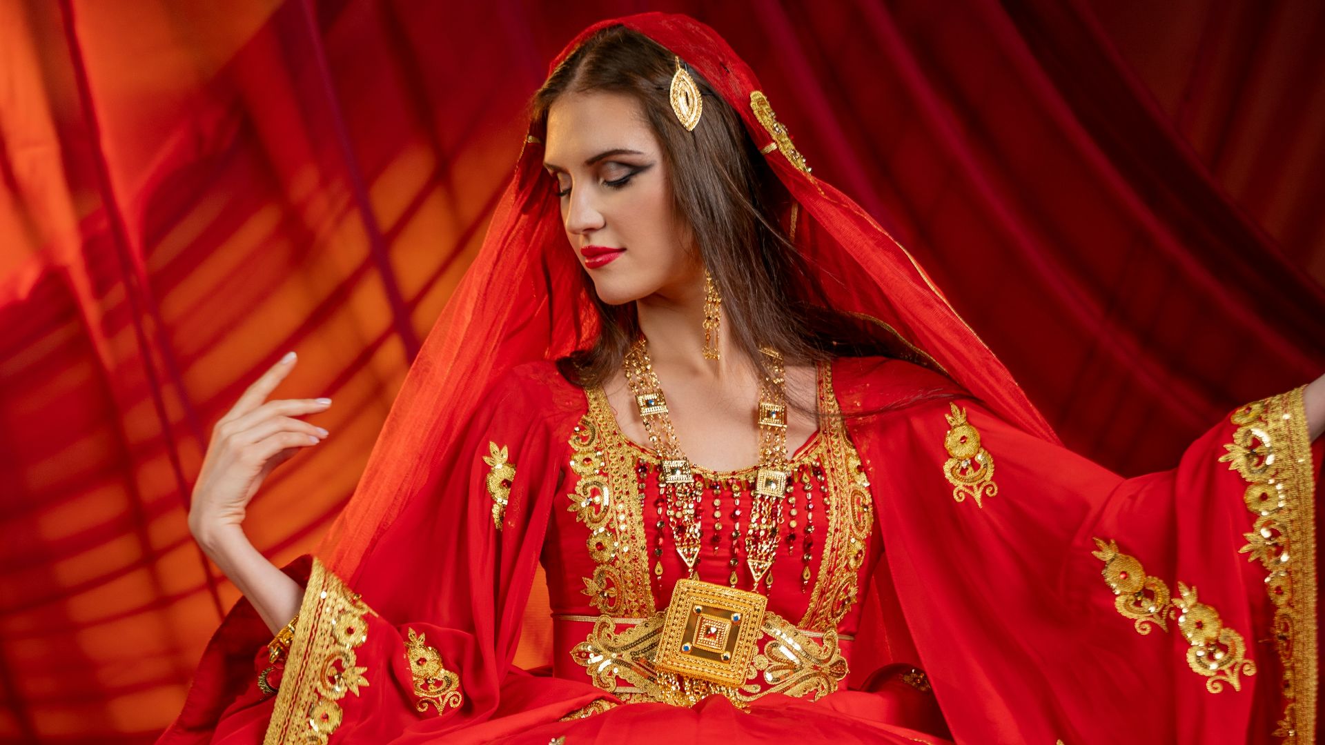 a woman in a red dress sitting on a rug