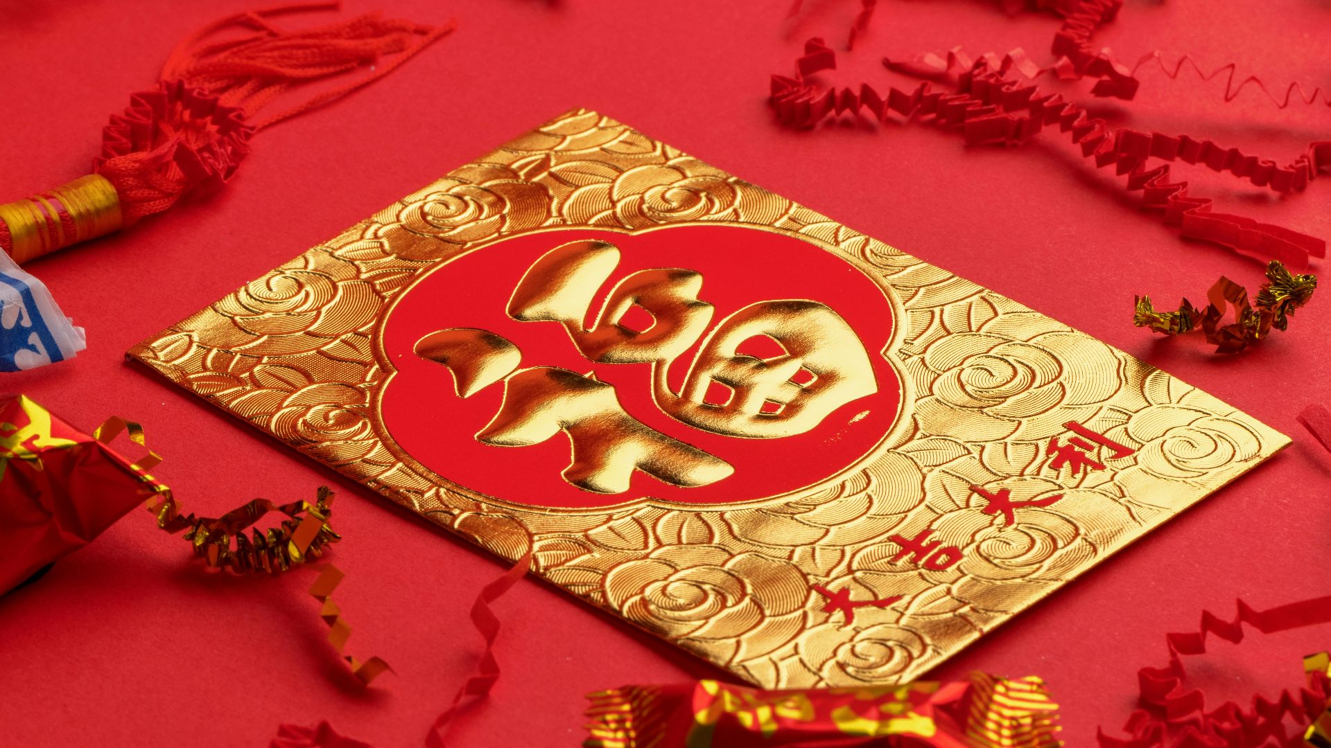 gold and white religious print book on red textile