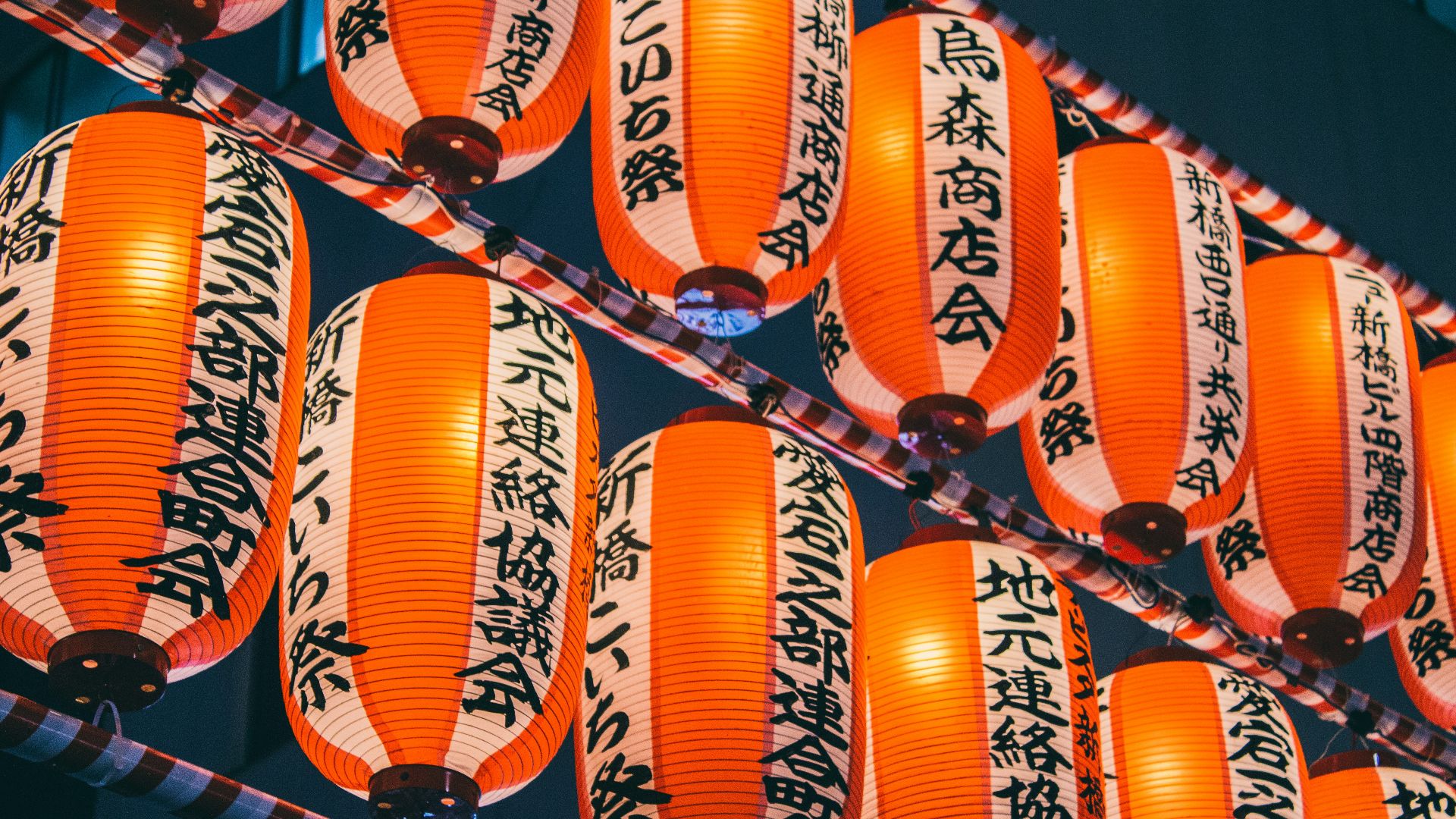 orange paper lanterns on black metal frame