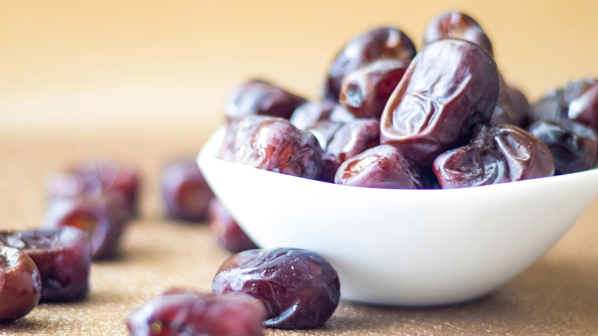 brown round fruit on white ceramic bowl