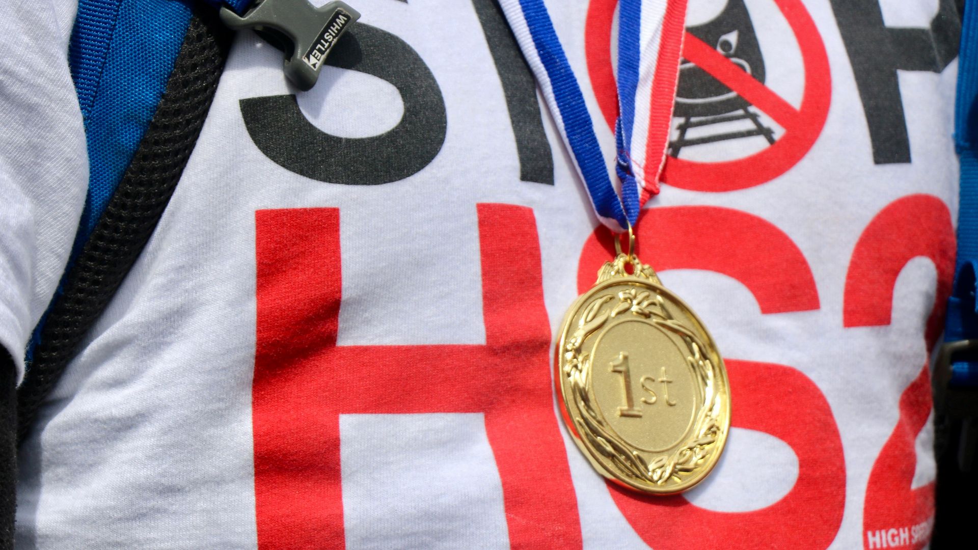 person wearing round gold-colored medallion