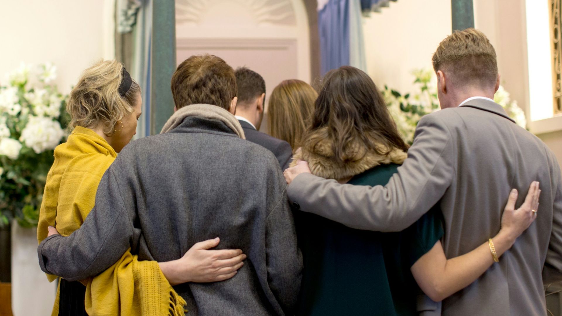 a group of people standing in front of a doorway