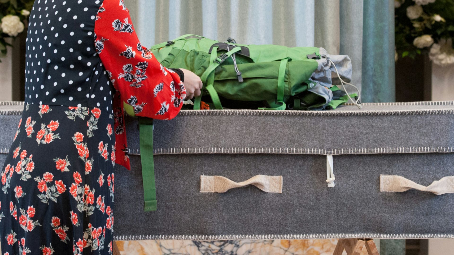 a woman standing in front of a suitcase