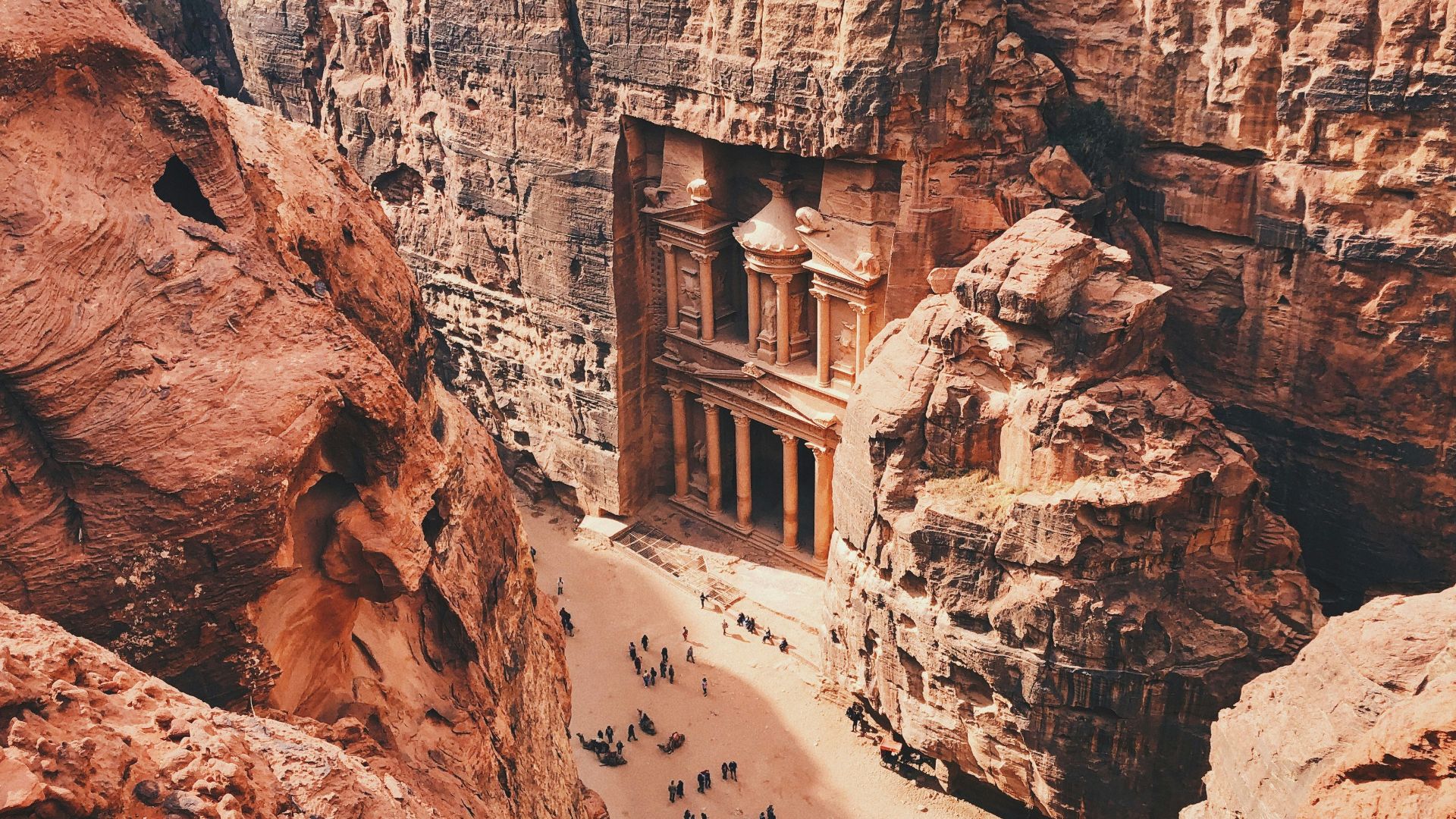 brown and white concrete building on brown rocky mountain during daytime
