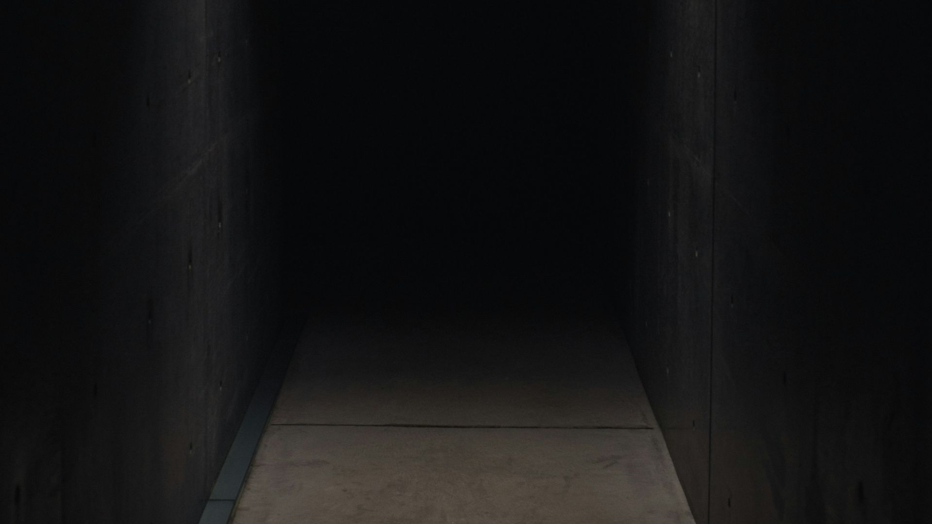 dark pathway lit with small light fixture