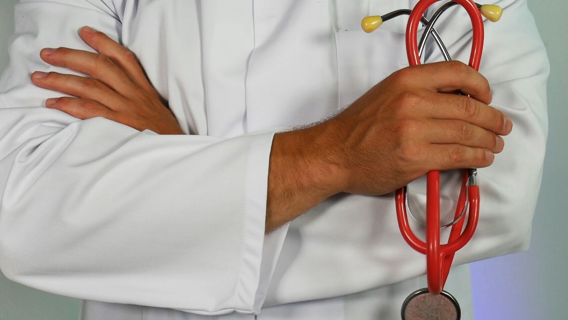 doctor holding red stethoscope
