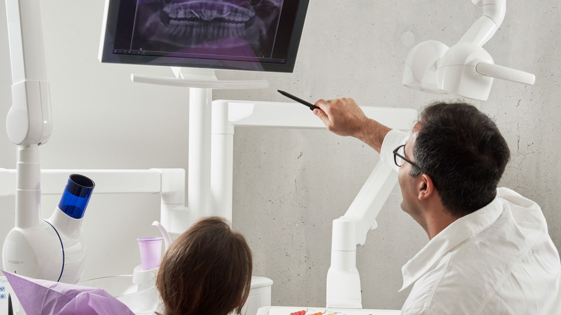 man in white dress shirt holding black pen