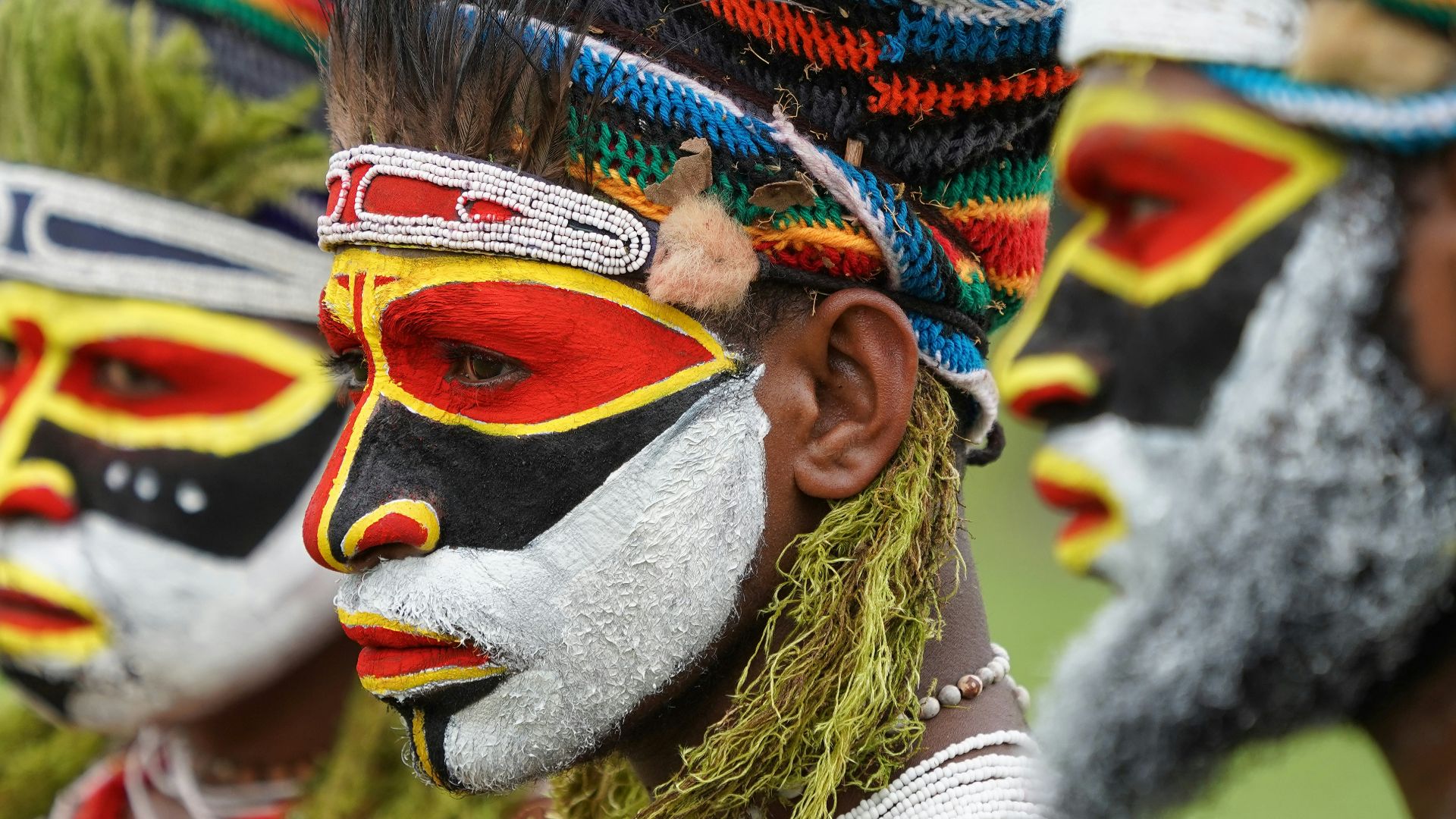 person wearing blue red and yellow knit cap
