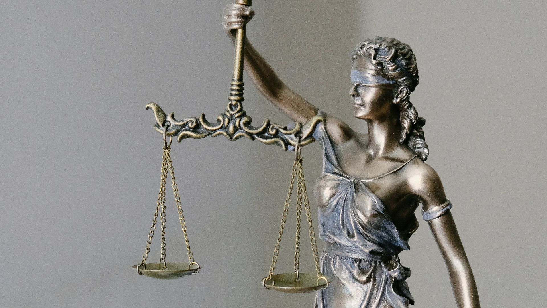 woman in dress holding sword figurine