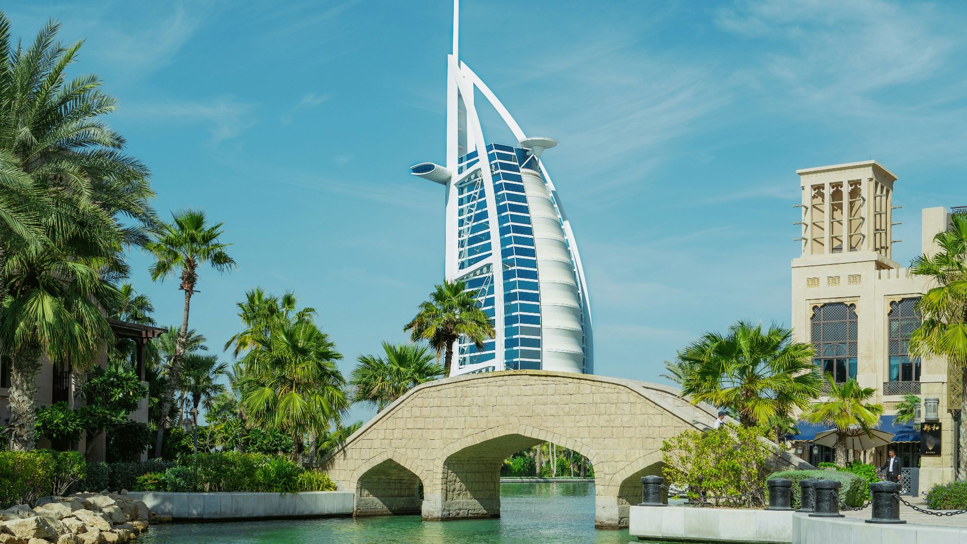a bridge over a body of water with a building in the background