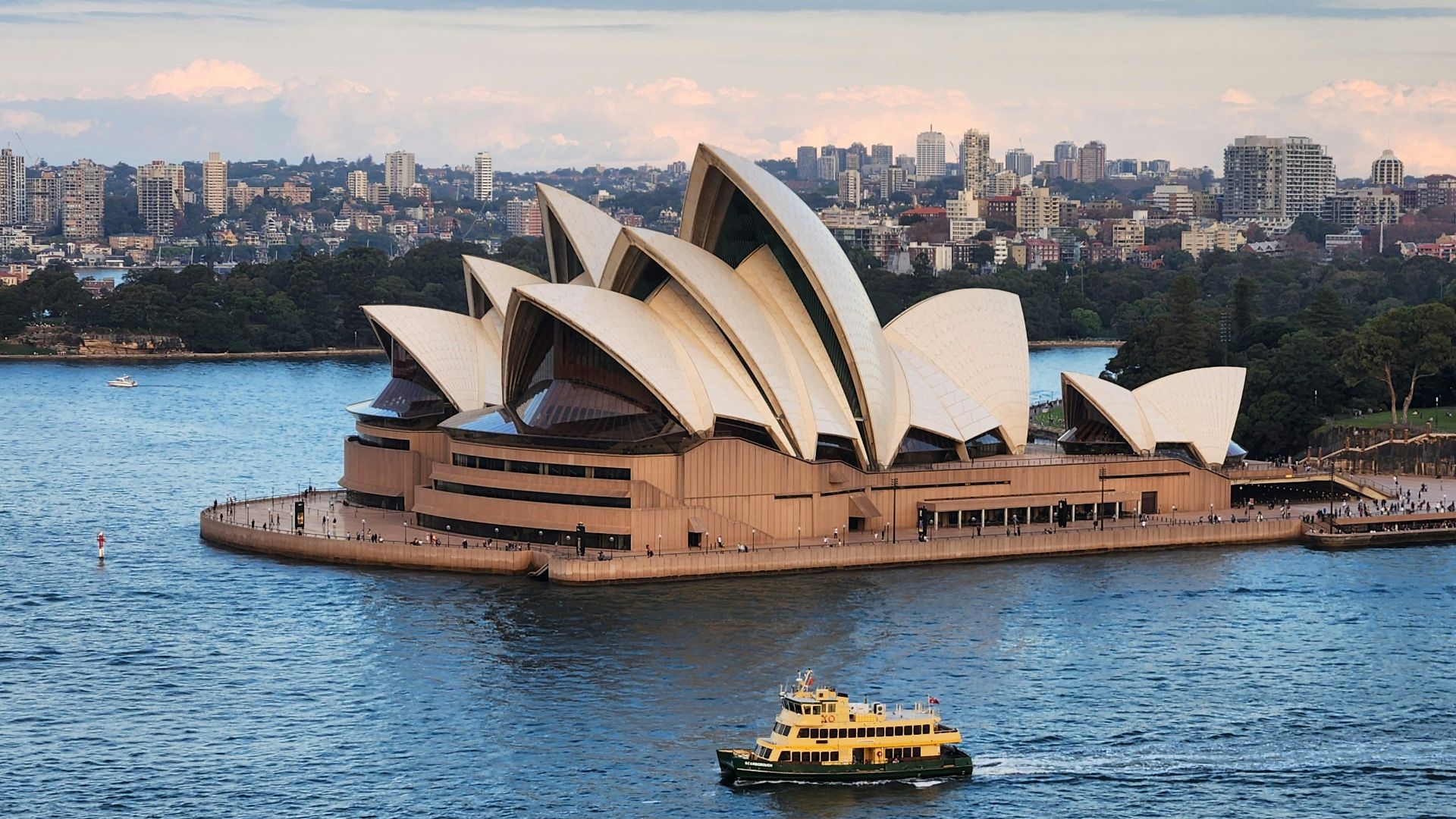 a boat is in the water near a large building