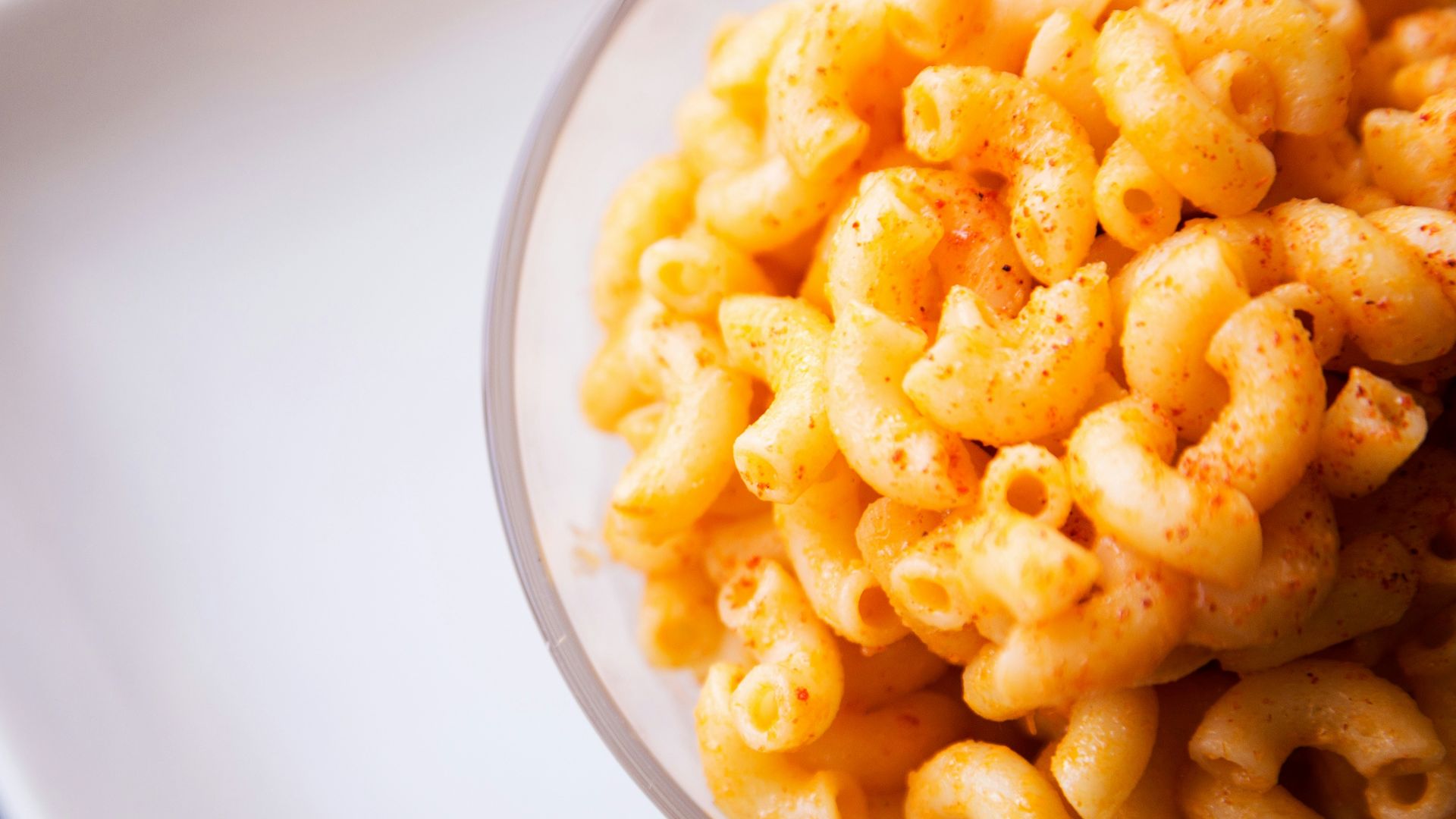 yellow pasta on clear glass bowl