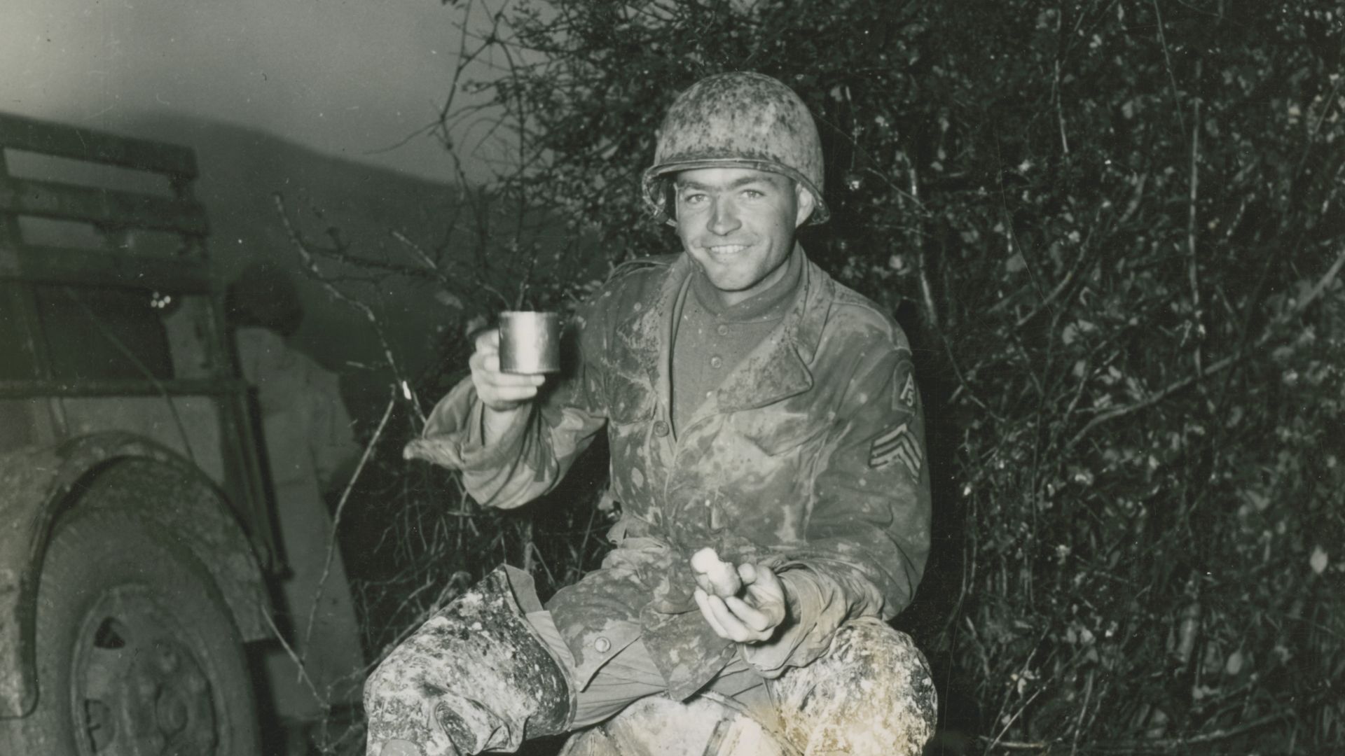 File:Sgt. Pierce Dewey, Crossett, Ark., of the 39th Combat Engineers, sits on a roll of wire drinking hot coffee and eating doughnuts, which are being served by an American Red Cross Mobile Unit. (49369307851).jpg
