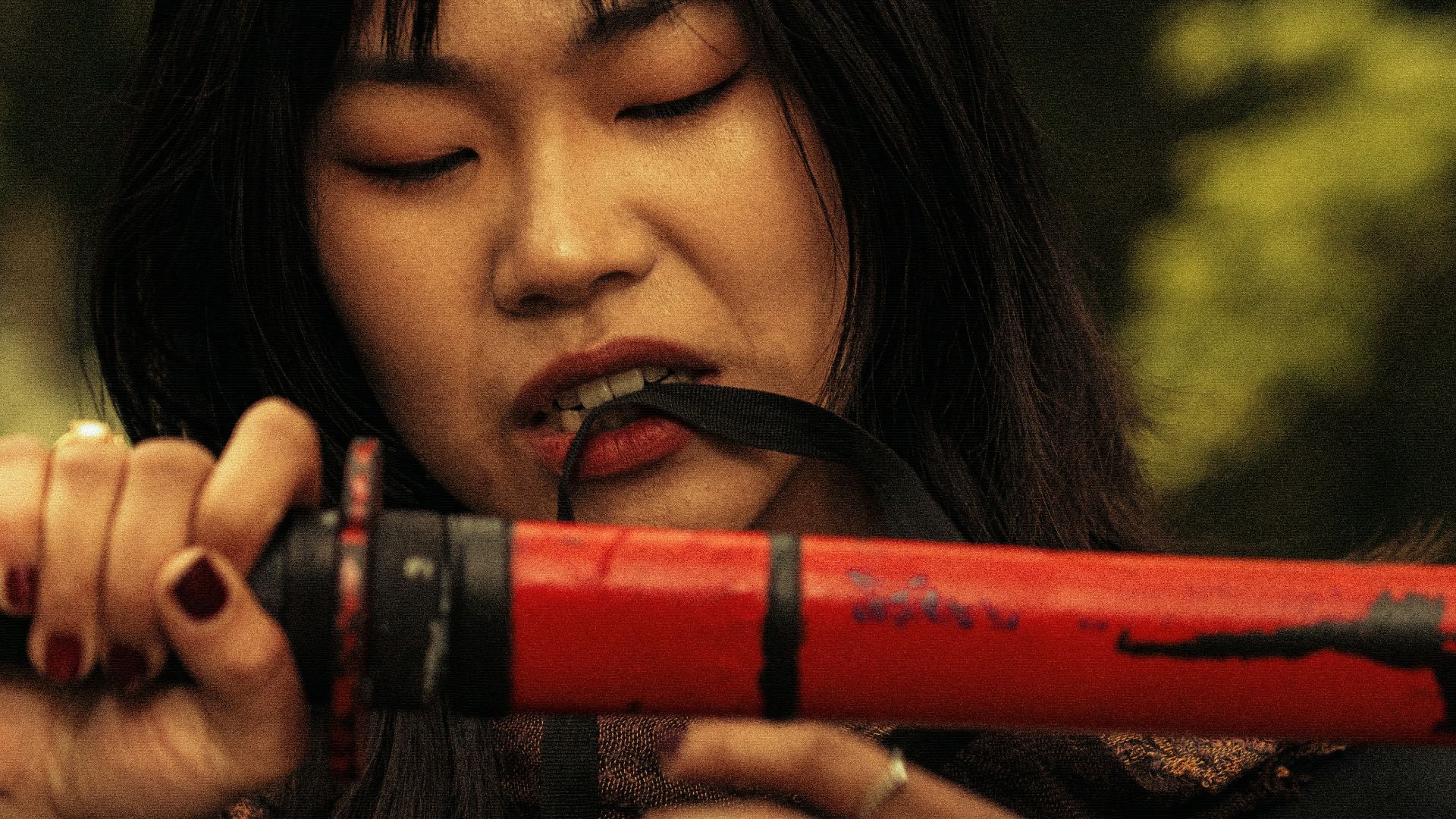 a woman holding a red object in her hands