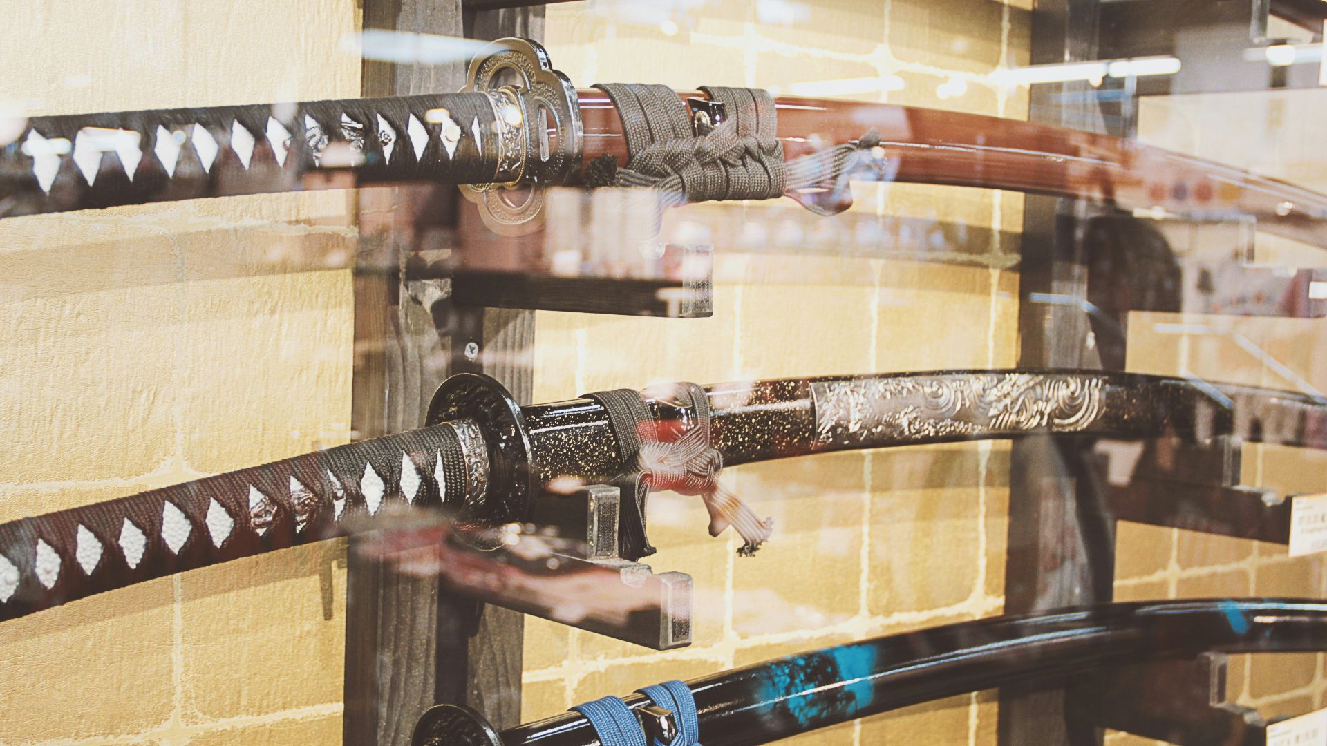 a display of different types of knives in a glass case