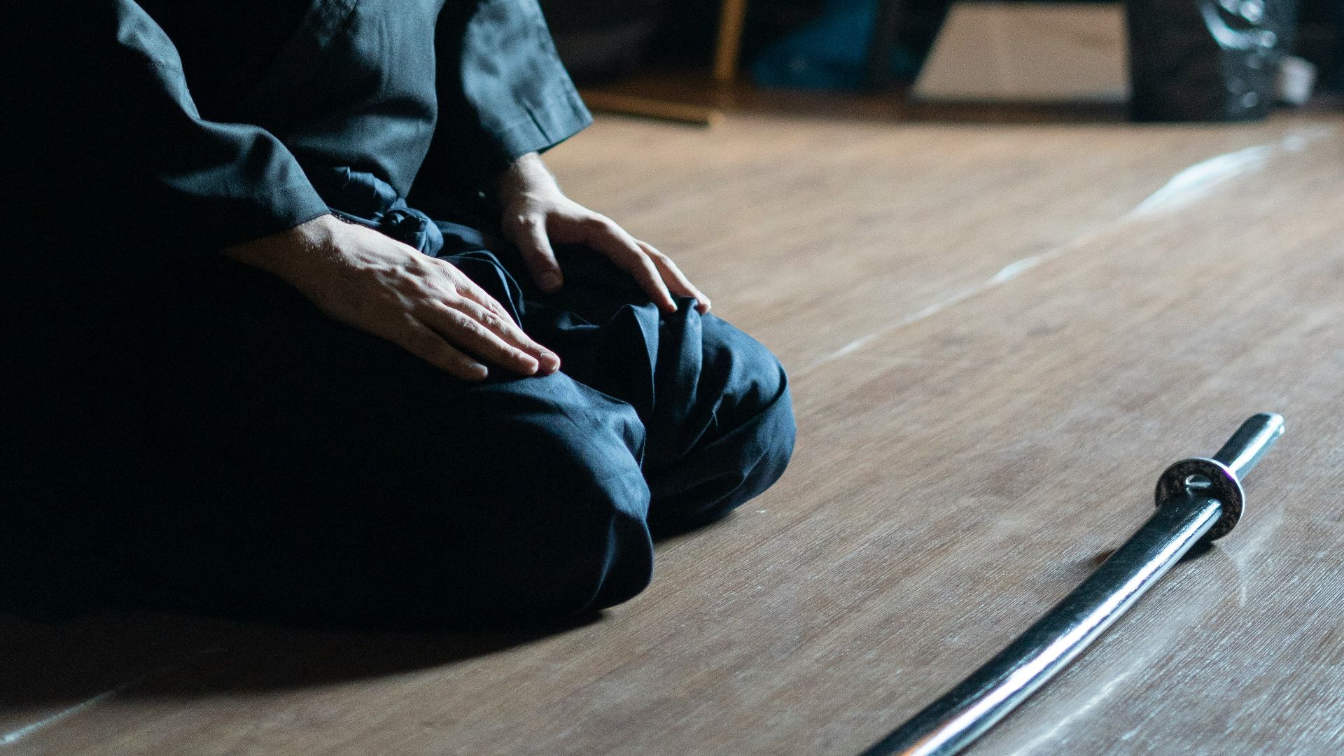 A man sitting on the floor with a hat on his head
