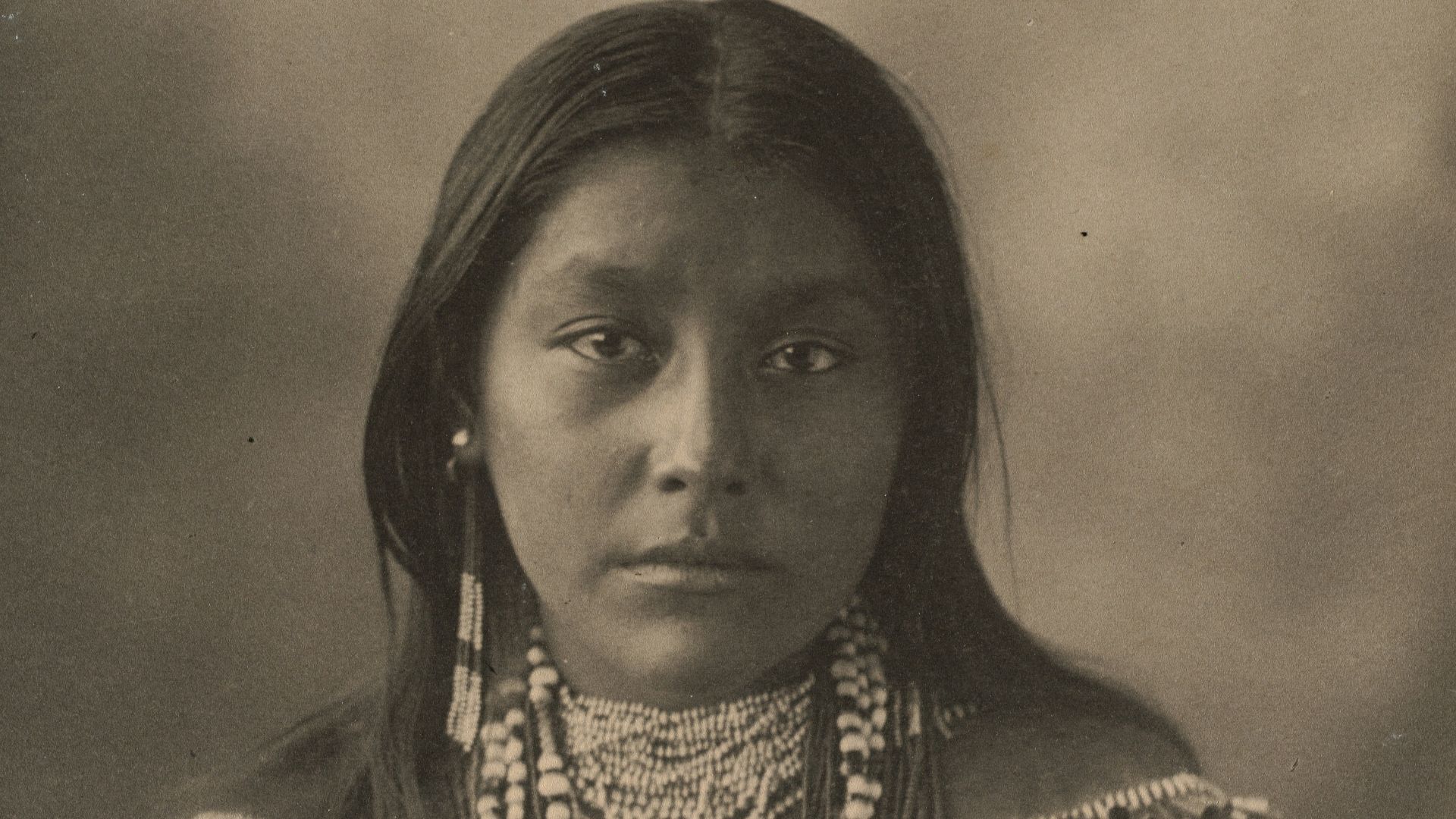 woman in black and gold dress