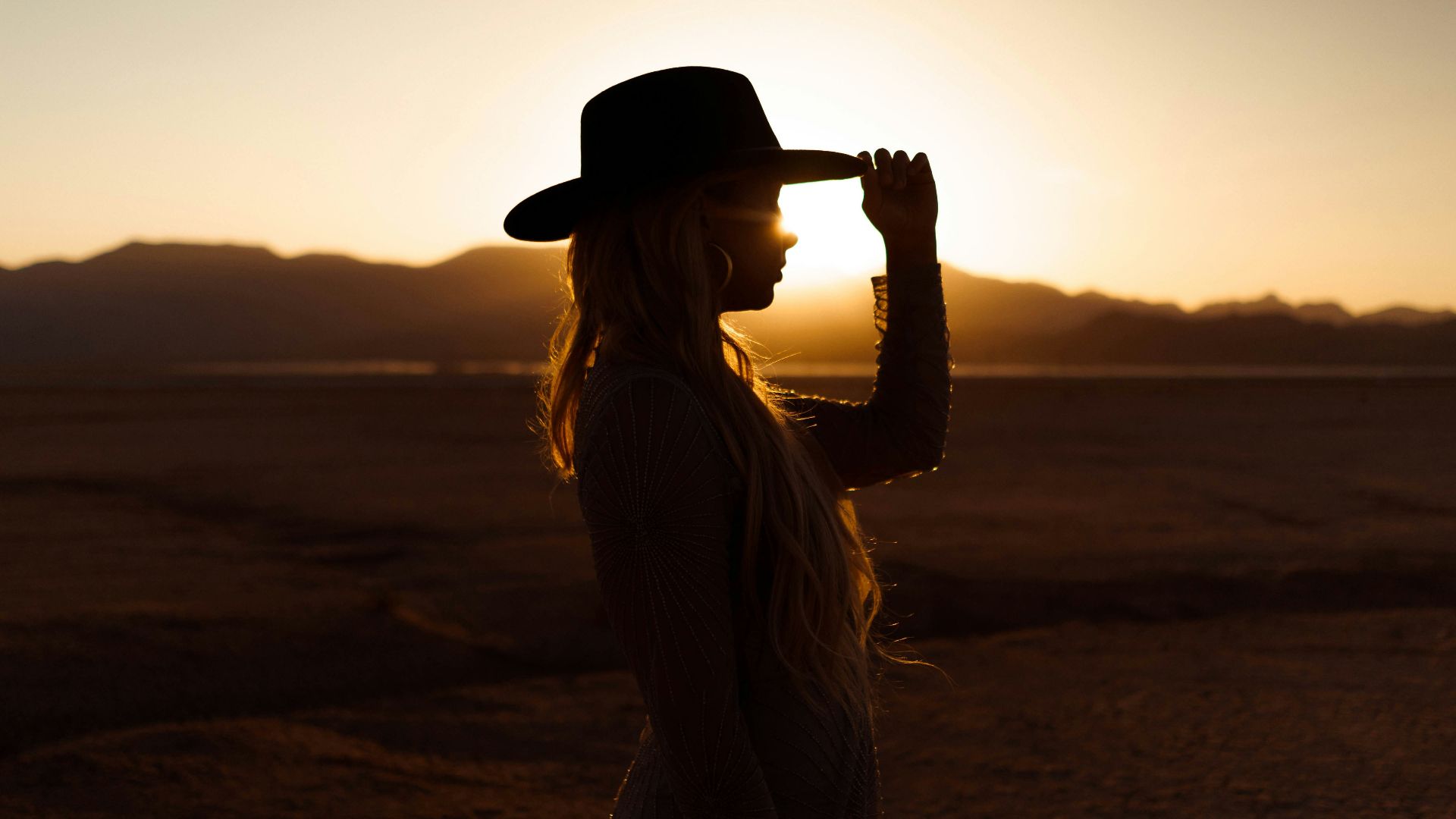 woman in white dress wearing black fedora hat