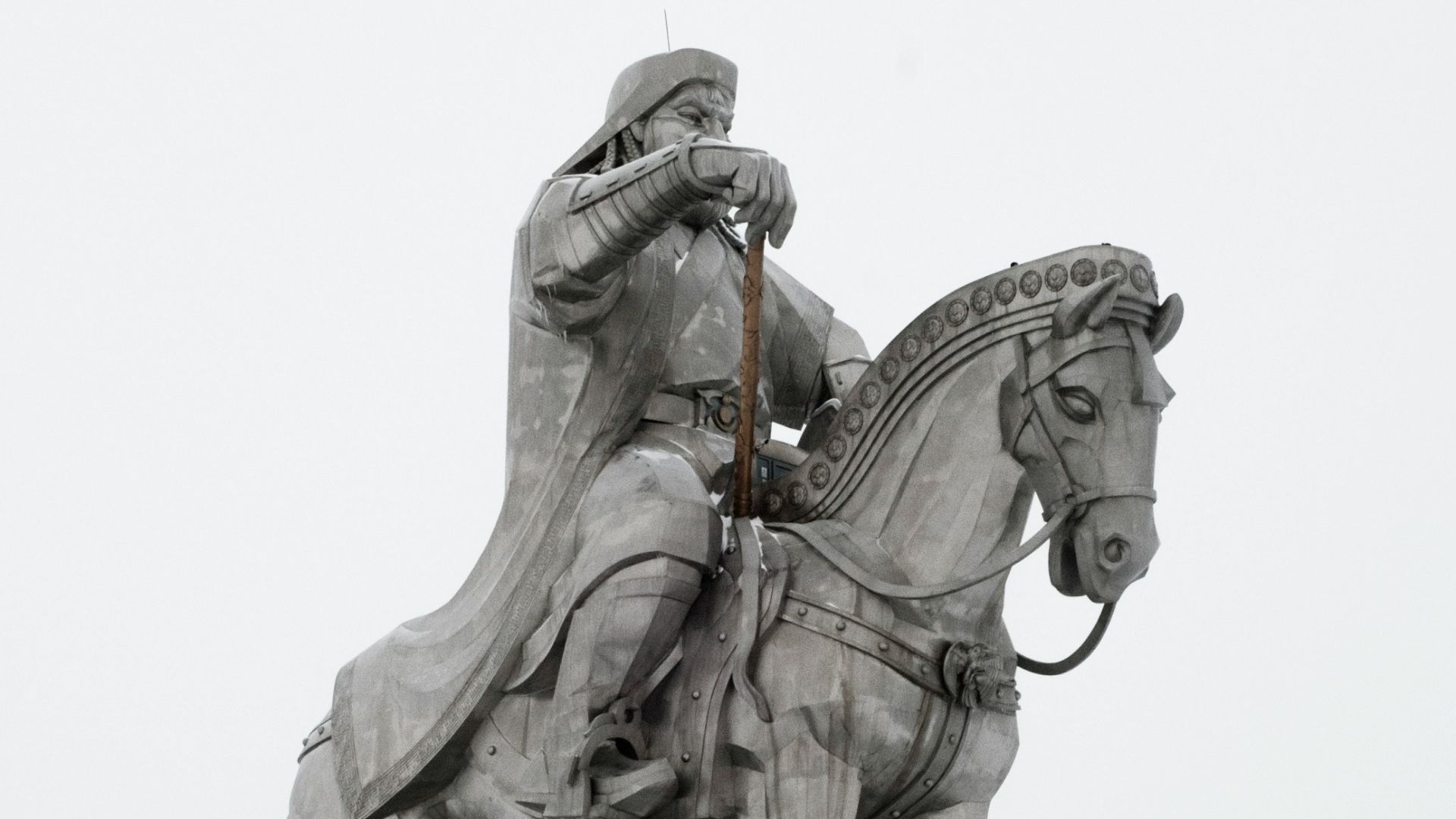 A statue of a man on a horse in the snow